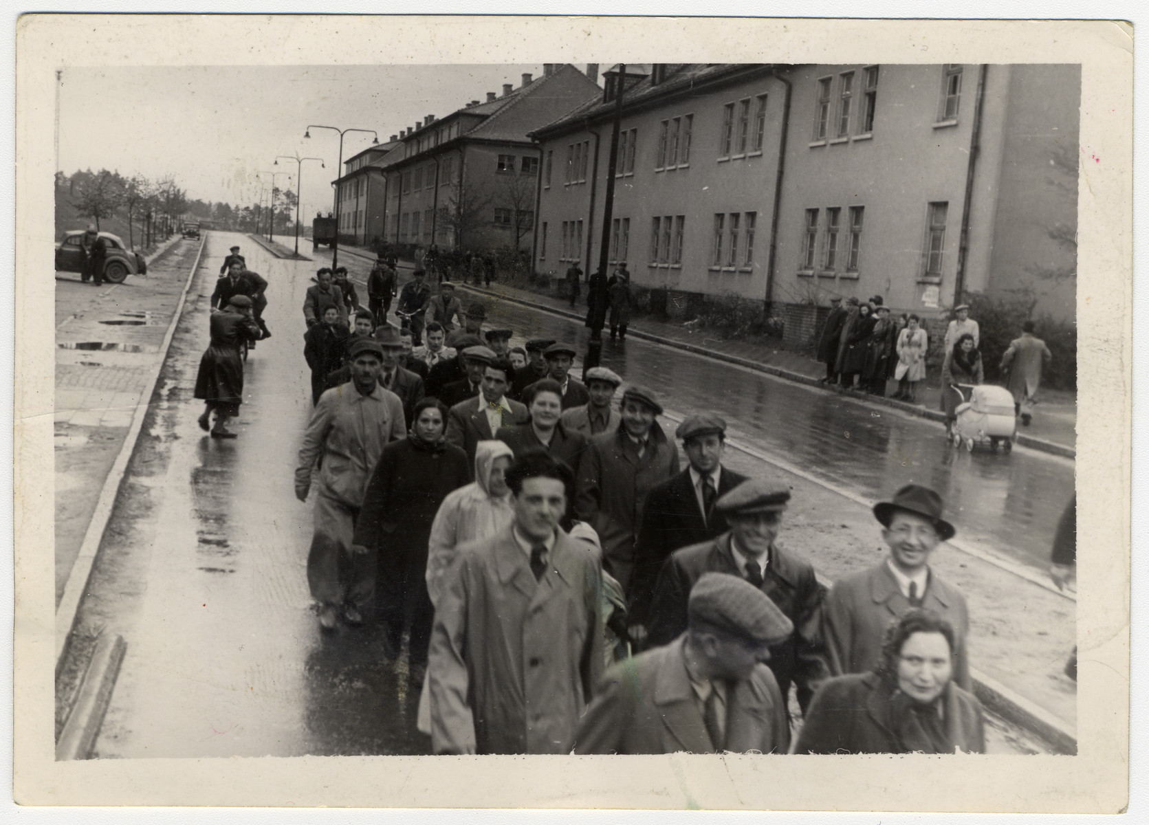 Jewish displaced persons march through the streets of the Bergen Belsen camp.

Among those pictured are Shloime and Sonia Proszkowicz.