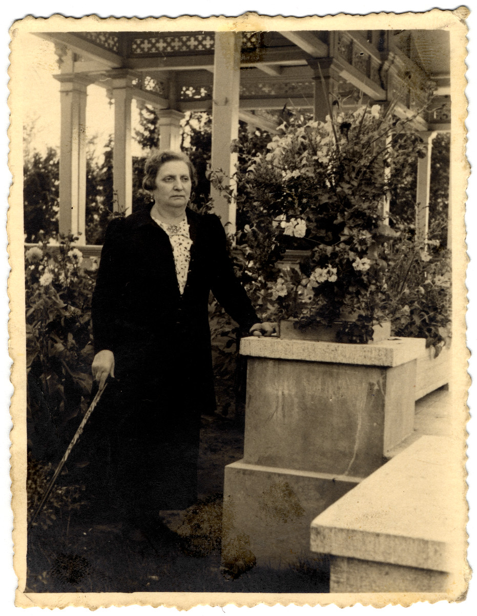 Close-up portrait of a woman from the Obsbaum family standing in her garden.