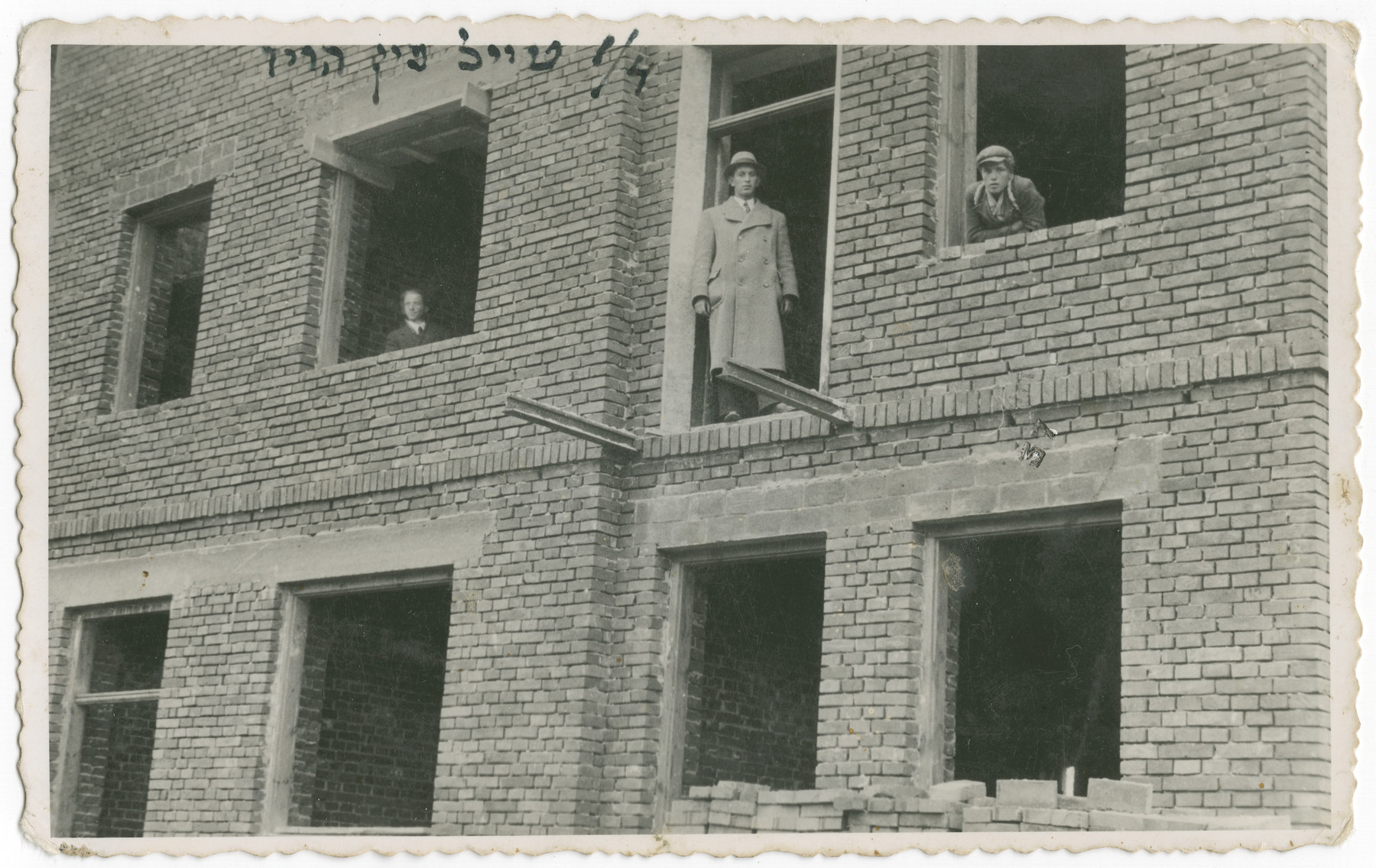 Members of the Nussbaum family poses by open windows of their apartment house which is under construction.