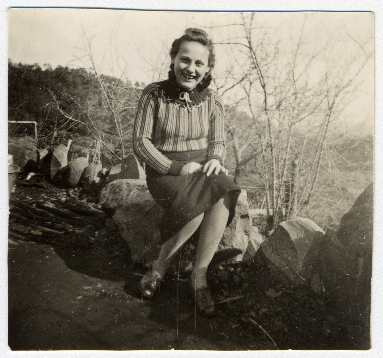 Lily Haber, an Austrian refugee, sits in a forest in Cyprus.