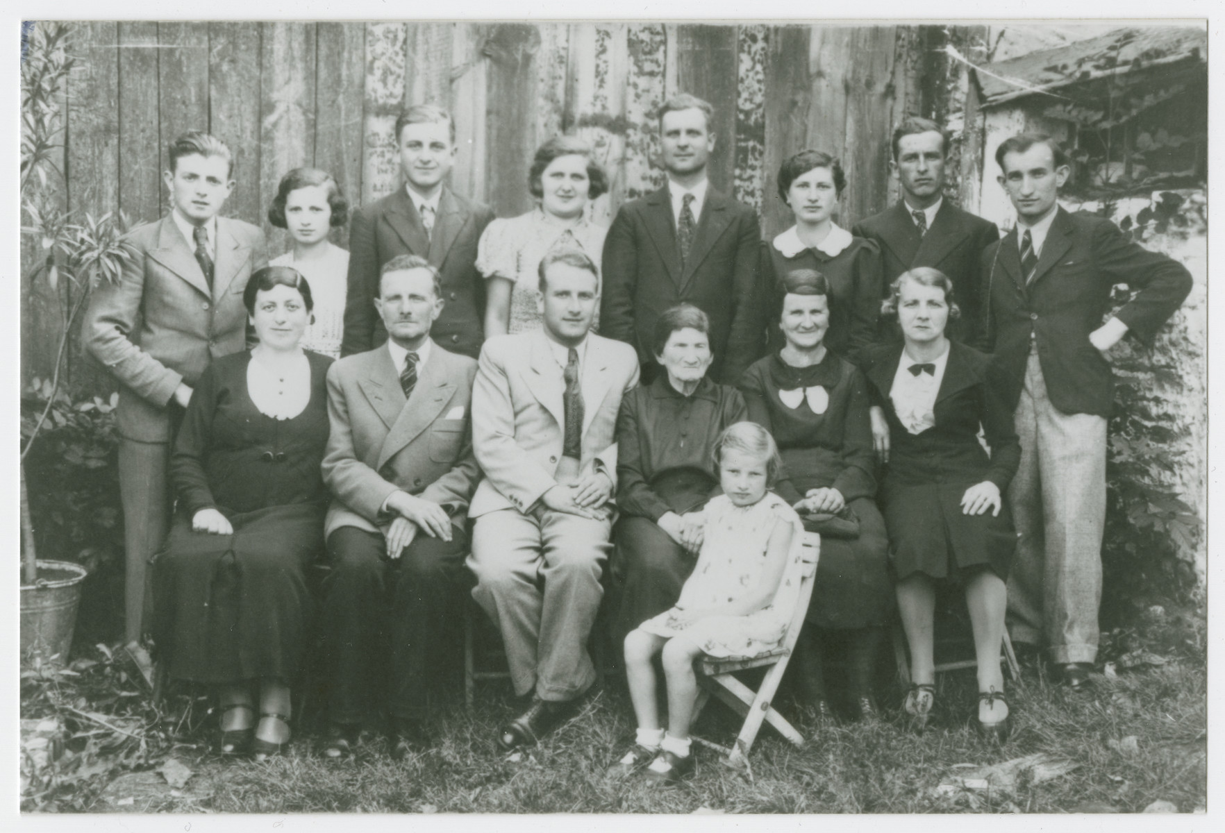 Prewar portrait of the extended Ring family in Krzepice, Poland.

Pictured left to right are front row: Sura Fajga Ring, Zeleg Ring, Russell Ring, Sura Ring, Brindel Ring and Deborah Ring.  The young girl in front is Mania Ring.

Back row: Henoch Ring, Henia Ring, Chemya Rosen, Srul Rosen, Liah Rosen, Etcho Rosen and Mendel Ring.