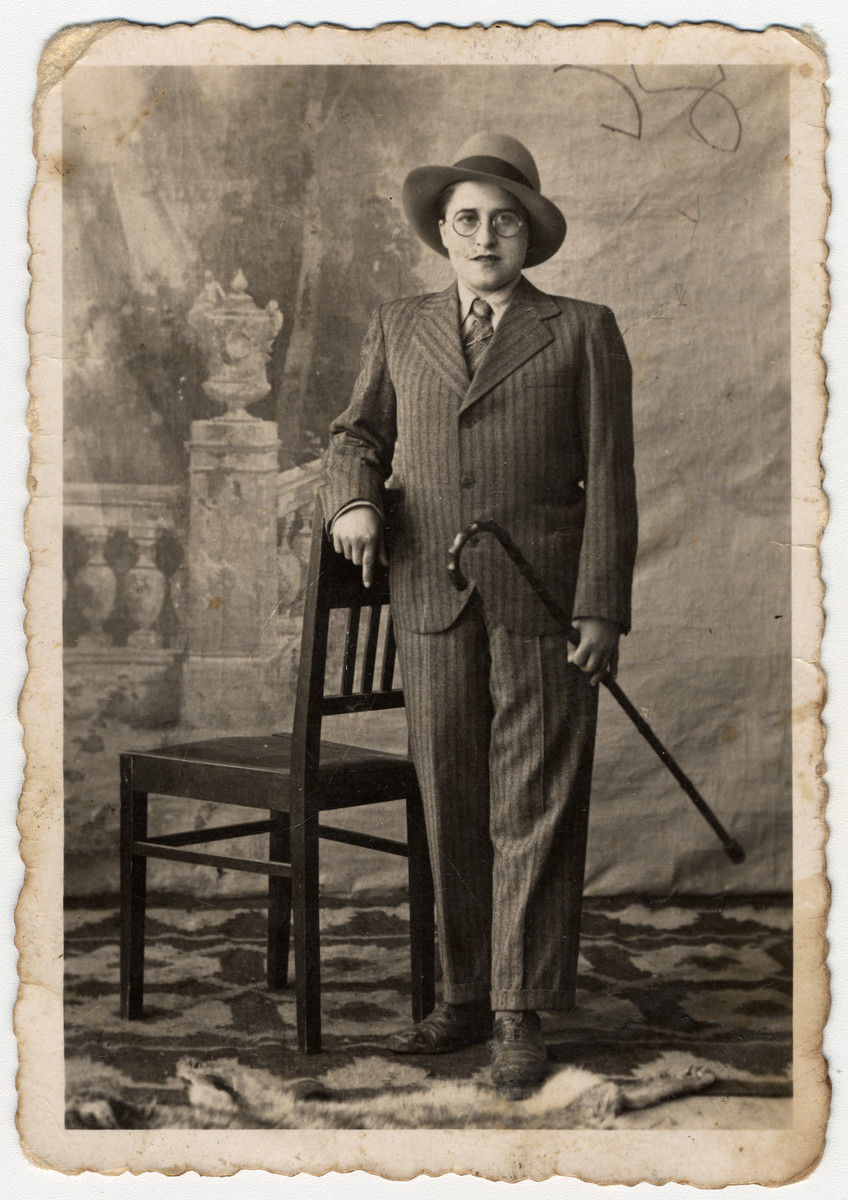 Studio portrait of a Romanian Jewish woman dressed up as a man to celebrate the holiday of Purim.

Pictured is Malka Pollak (later Herskovitz).