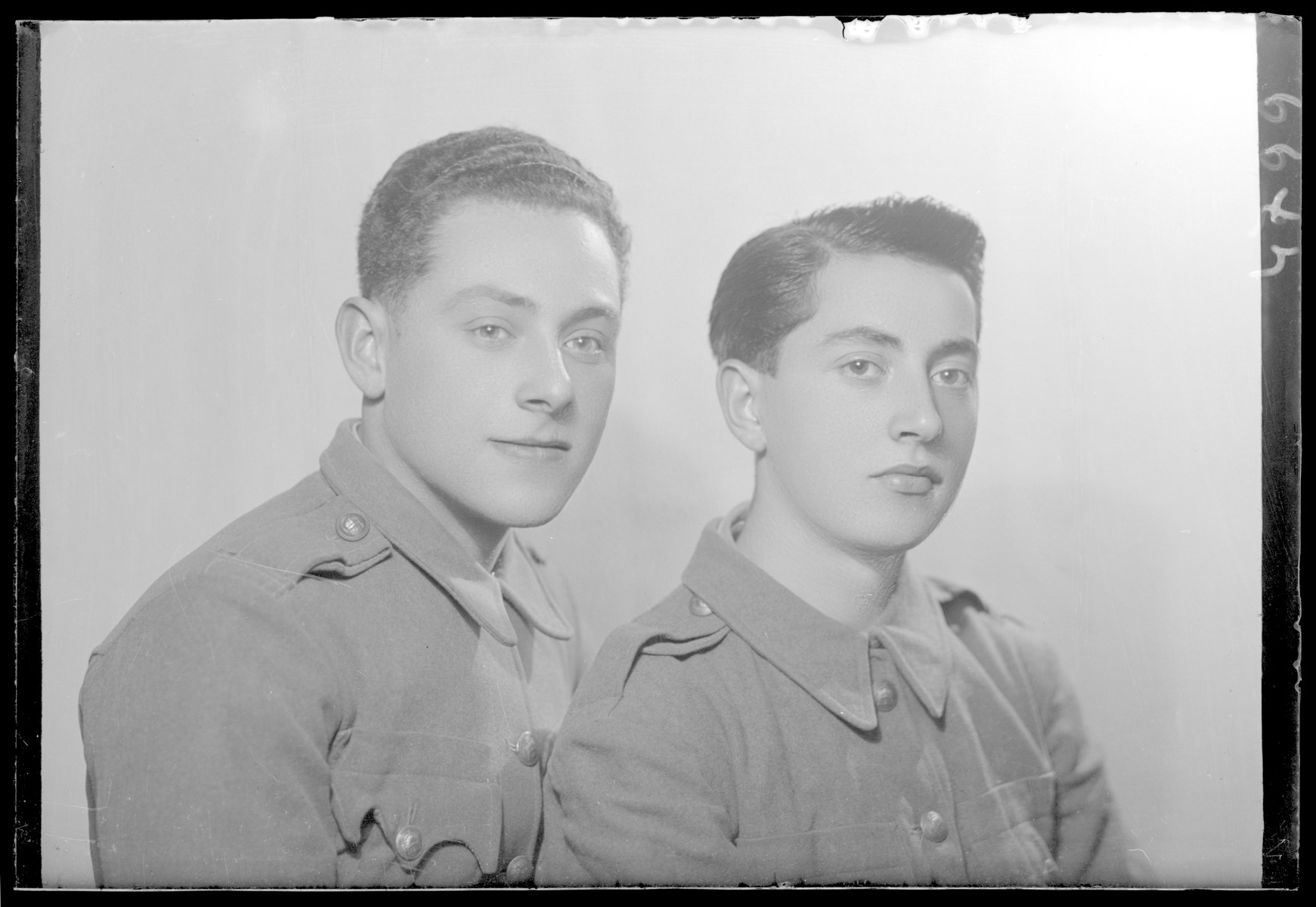 Studio portrait of two young men, one of whom is Miklas Fried.