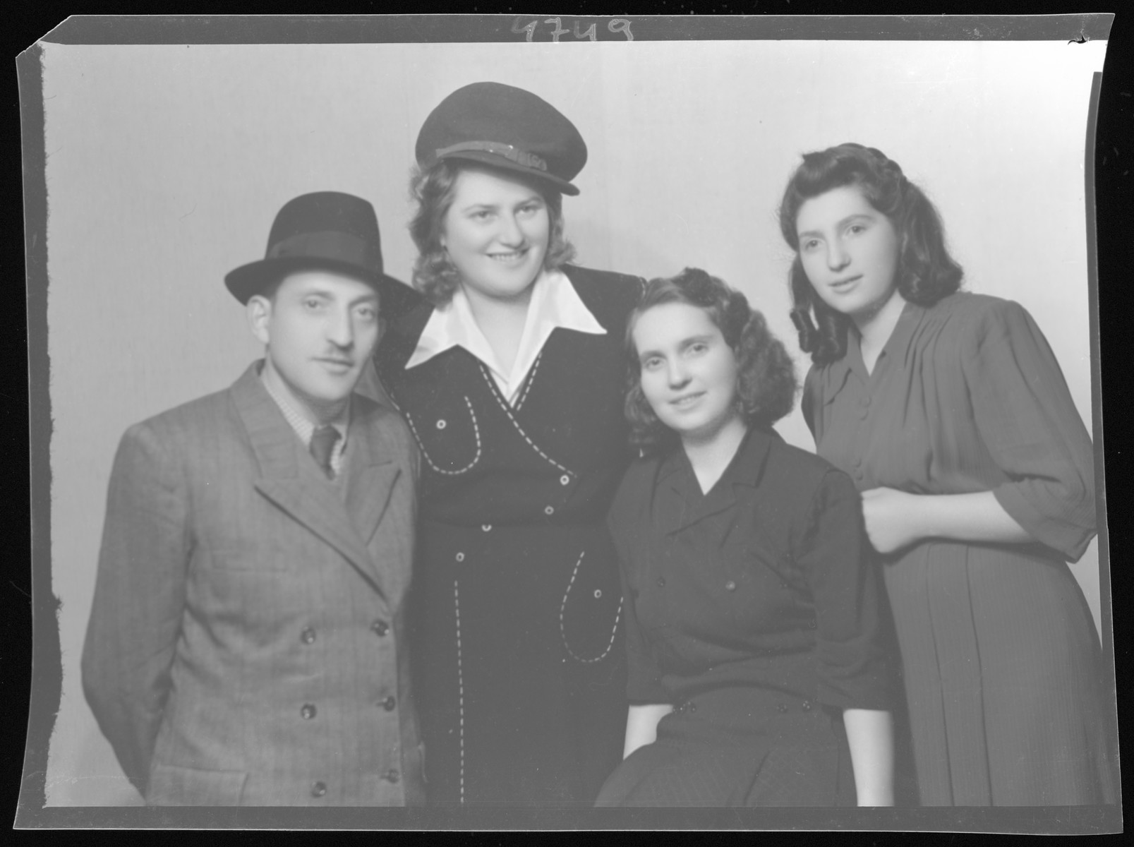 Studio portrait of the family of Markusz Schvartz.

Hana Elena Schvartz is the tall woman in the hat.  She is the only member of her immediate family to survive the Holocaust.