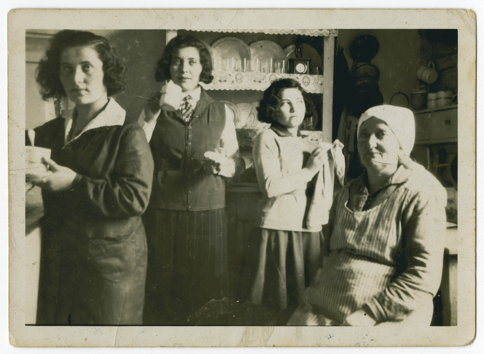 Jechet Kielmanowicz sits in her kitchen surrounded by three of her daughters.

Pictured from left to right is Ida (Jetta), Gisa, either Simcha or Esther and Jechet Kielmanowicz.