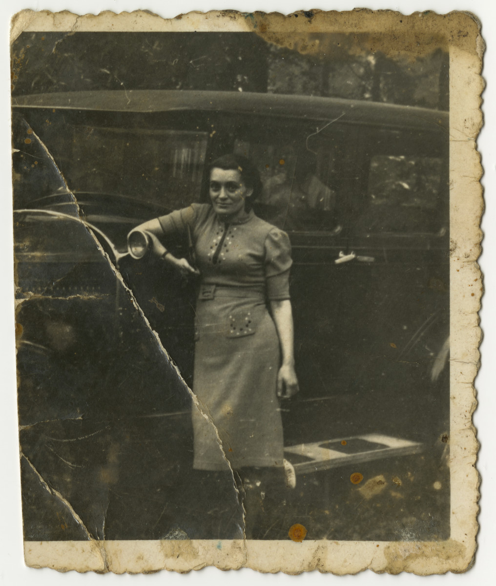 Prewar portrait of Mania (last name unknown) leaning against an automobile and given to Fela Zyndorf in the Bobrek concentration camp.

The original caption reads: "As a show of friendship to my camp friend -- Mania."