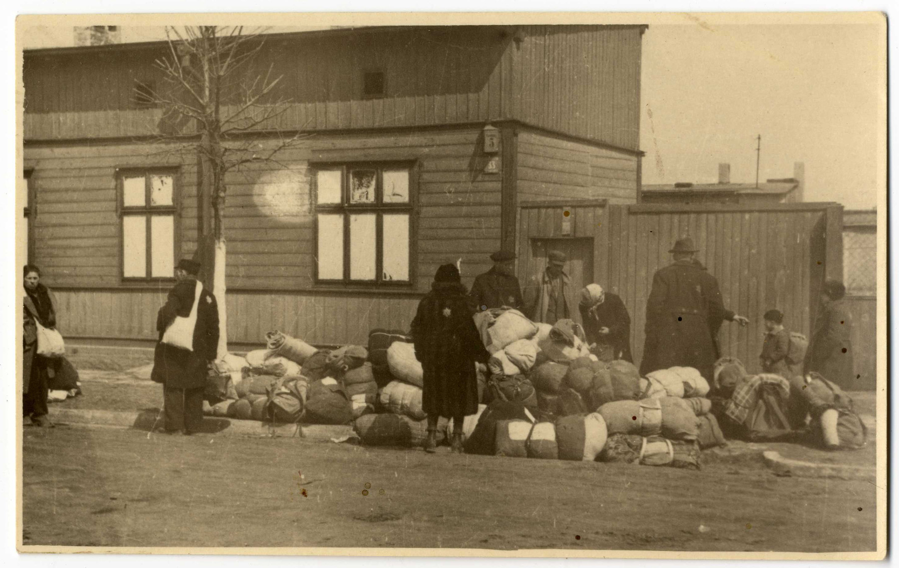 Jews deposit their bundles on the pavement before their deportation from the Lodz ghetto.