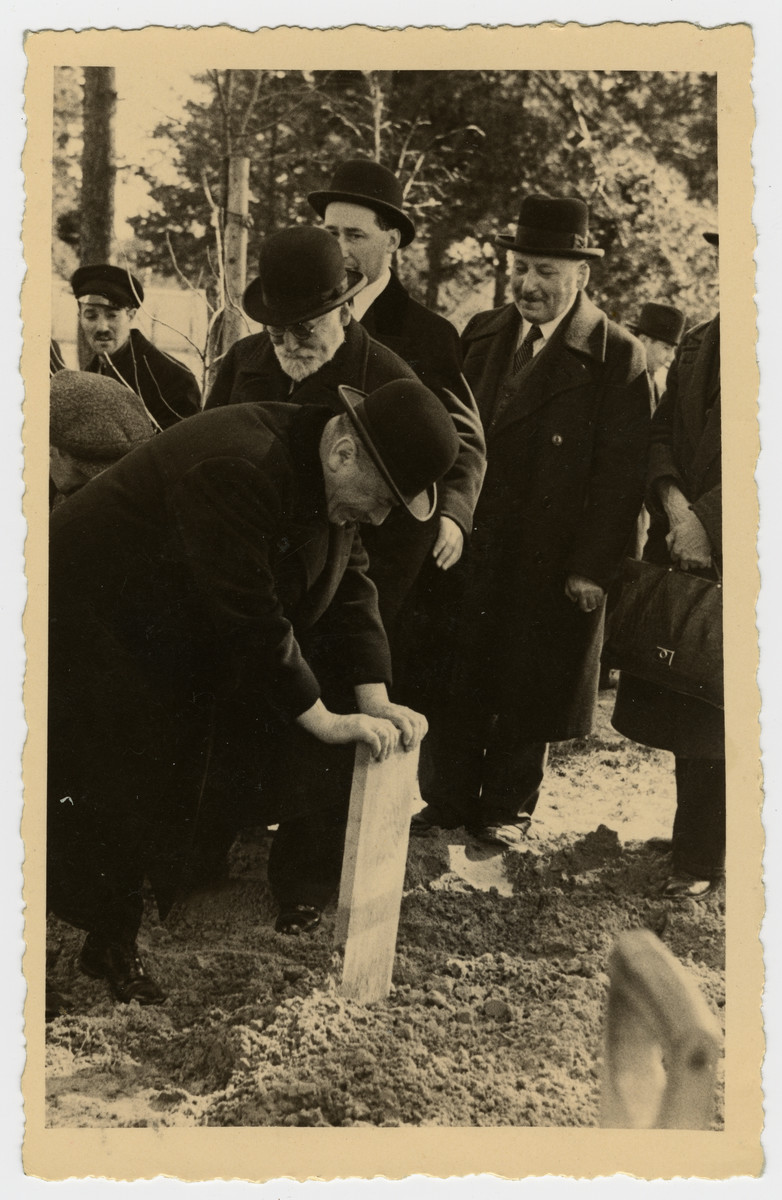 Ilya Albin, plants a grave marker for his mother, Freida Albin.