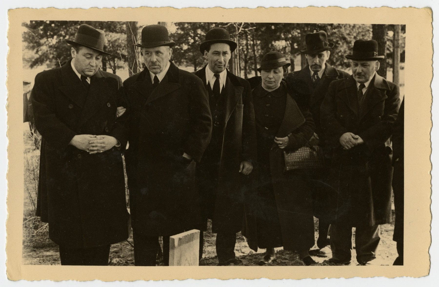 Mourners stand by the grave of Freida Albin.

Pictured are Papa, Aron, Zilla, Harri, and Abraham.