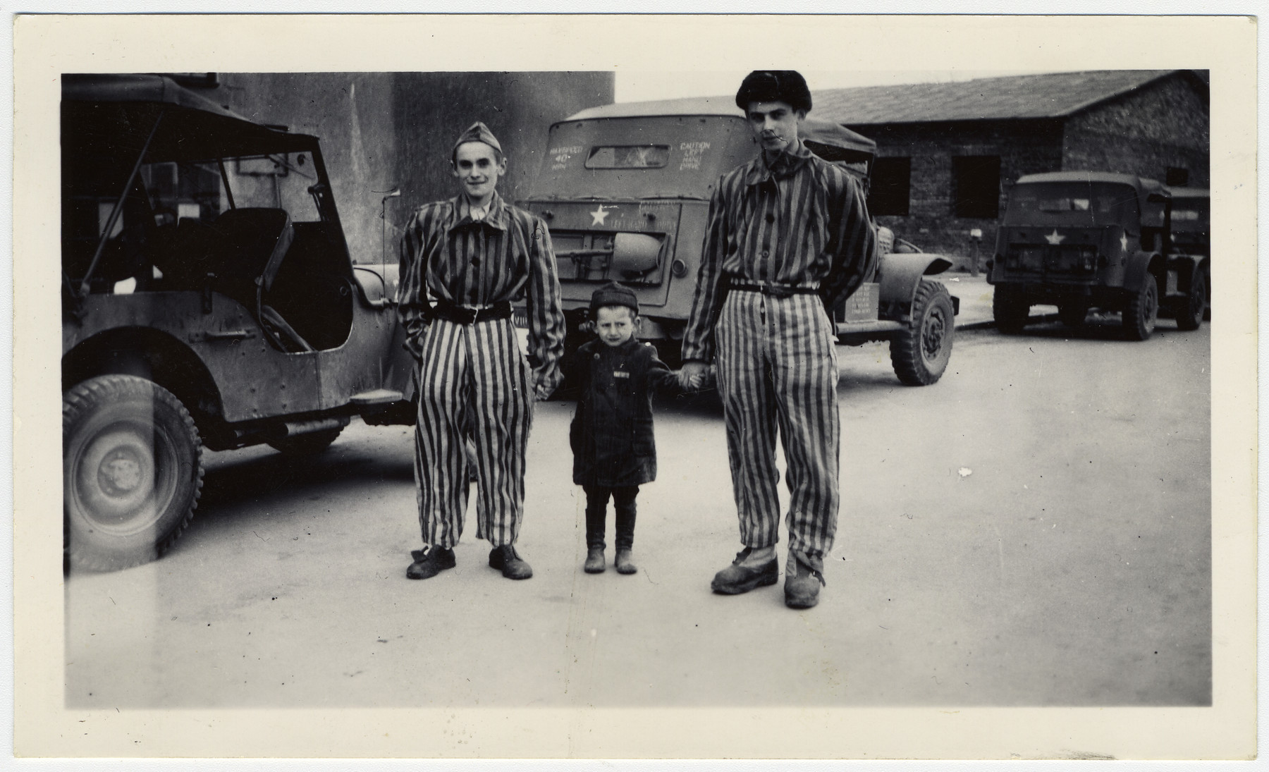 Josef Schleifstein poses with two survivors at Buchenwald.

Original caption reads:  Youngest person -- 4 yrs old 3 yrs in Buchenwald!