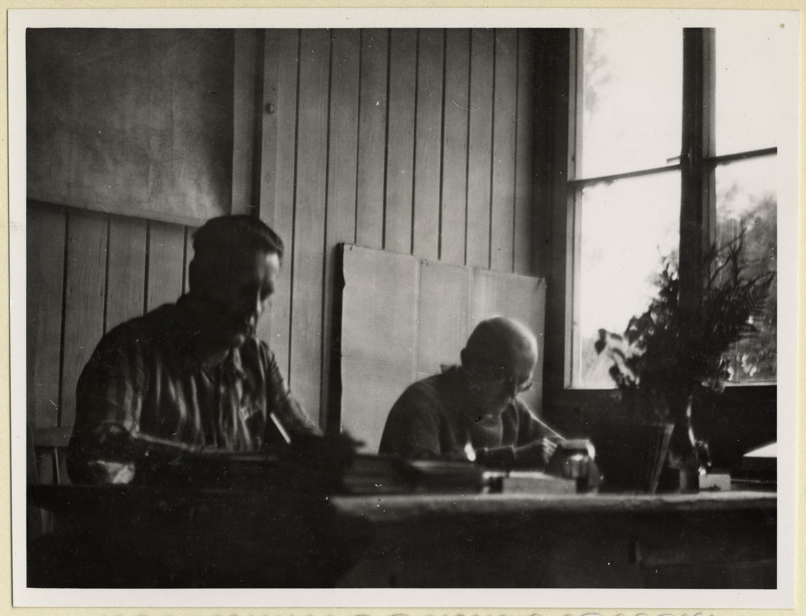 Czech political prisoners work in an office in the Dachau concentration camp.

Seated on the right is the priest, Dr. Frantisek Nemec.

The photograph was taken by Karel Kasak and developed by Maria Seidenberger.