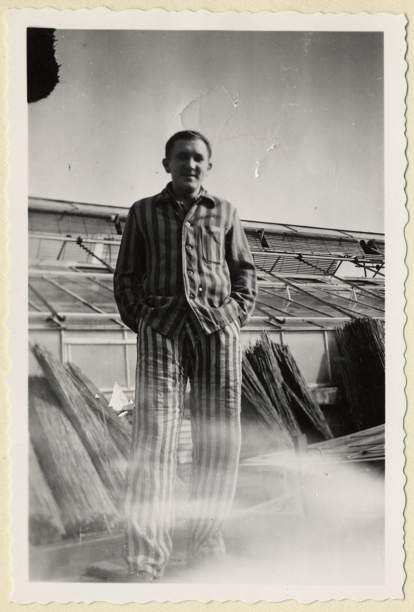 Portrait of Jiri Hell, a Czech political prisoner standing next to the greenhouses of the "Plantage" of the Dachau concentration camp.

The photograph was taken by Karel Kasak and developed by Maria Seidenberger.