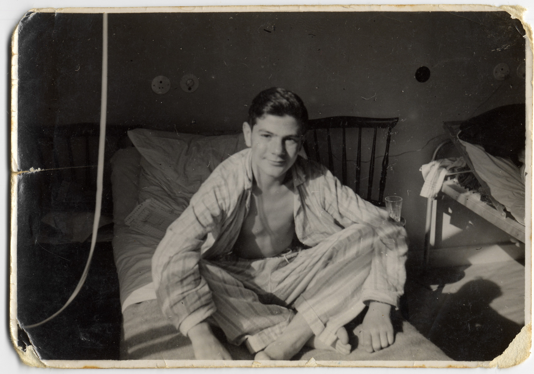 Close-up portrait of Chaim Kozienicki sitting on a hospital bed where he is recuperating in Sweden.