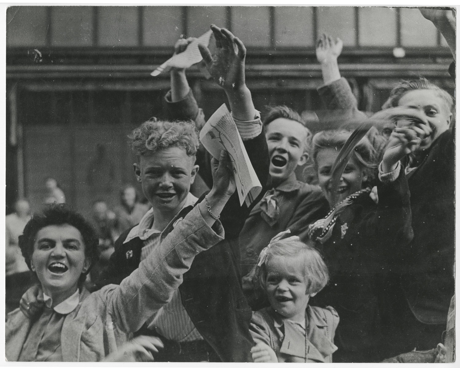 Dutch citizens celebrate the liberation of Utrecht.

Original caption reads:  "Crowds celebrating victory in the streets of Utrecht, Holland, are fired on by Nazi fanatics hiding in a building overlooking the parade.  After a sharp skirmish, the Germans were captured by Dutch patriots and the celebration was resumed.  Here, as the Nazis open fire on the victory crowds, Dutch patriots go into action".