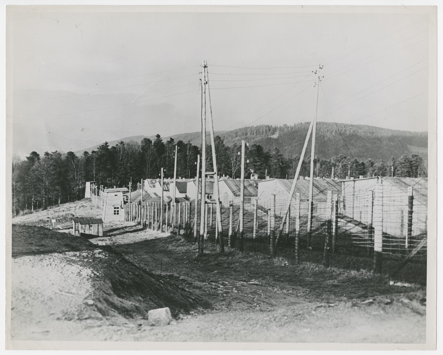 A view of the Struthof concentration camp in Echirmeck, France.

Original caption reads:  "This is a view of the Struthof concentration camp in the Echirmeck area of France.  Barbed wire fencing encloses the crude buildings where 8,000 French patriots are reported to have been gassed by the Germas and then cremated in huge ovens".