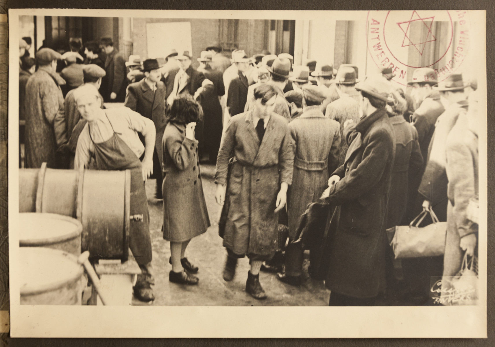Refugees gather outside the facilities of the Jewish Refugee Aid Committee of Antwerp.