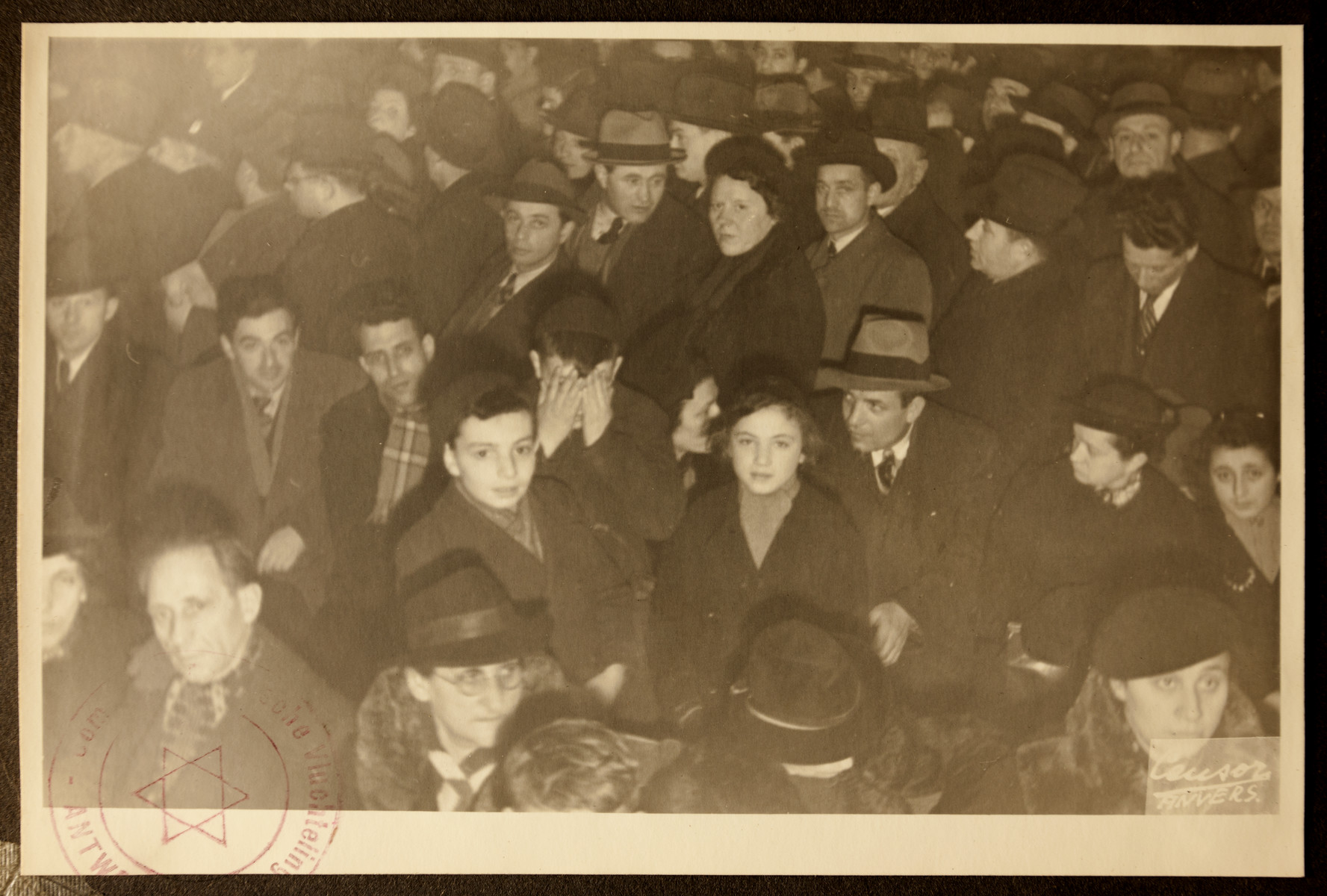 Refugees crowd into the offices of the Jewish Refugee Aid Committee of Antwerp.