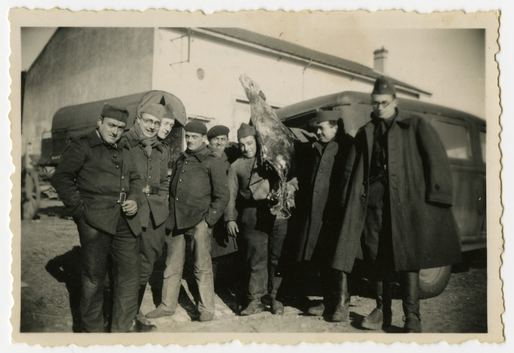 Group portrait of French soldiers.

Included are Alexander Markon, a Jewish immigrant from Lithuania.  One of the soldiers is holding an animal carcass