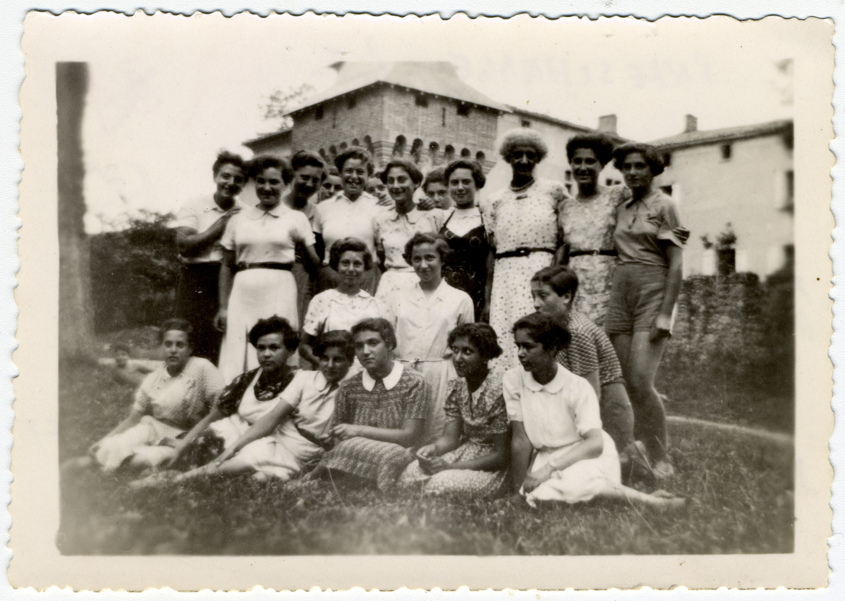 Young women and teachers pose for a group picture at the children's home of Chateau de la Hille.

Seated in foreground, from left: Almuth Koenigshoefer, Else Rosenblatt, Dela Hochberger, Lixie (Alix) Grabkowicz, Inge Helft and Edith Moser. Second row, kneeling, from left: Ilse Wulff, Margot Kern. Girl at right, possibly Martha Storosum.

Rear row, from left: Inge Joseph, Ruth Schuetz, Friedl Steinberg, (head in rear) Ruth Herz, Edith Goldapper,  (head in rear) unidentifiable, Ruth Klonower, (head in rear) Helga Klein, Inge Schragenheim, teacher Irène Frank, Ilse Bruenell, Rita Leistner.

Helft and Hochberger were caught fleeing to Switzerland in 1943, then deported and murdered in Auschwitz. Koenigshoefer, Rosenblatt, Moser, Wulff, Kern, Joseph, Goldapper, Klonower and Schragenheim escaped illegally to Switzerland in 1943 and survived. The others were hidden in Vichy France and survived.