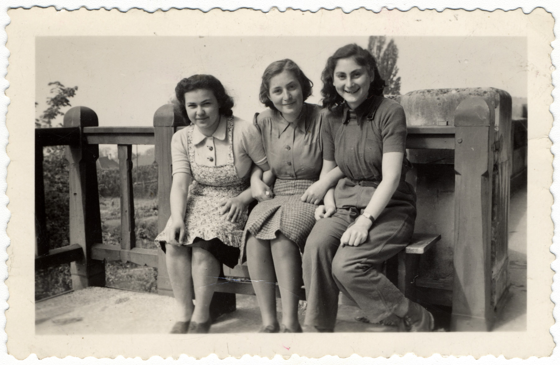 Three teenage girls sit on the terrace of the Home General Bernheim in Zuen, Belgium. 

From left are Else Rosenblatt, Lotte Nussbaum and Ruth Klonower. All came to La Hille in 1941.