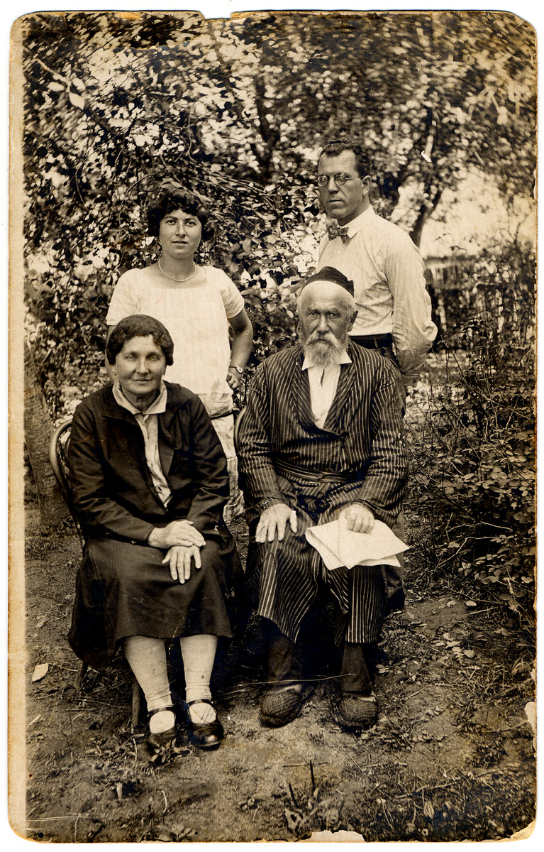 Members of the Rosenthal family pose in their garden.

Pictured are Bela Rozenthal, Meir Tzvi Rozenthal, Sheindel (perished 1942) and Avraham Kleiman (survived).