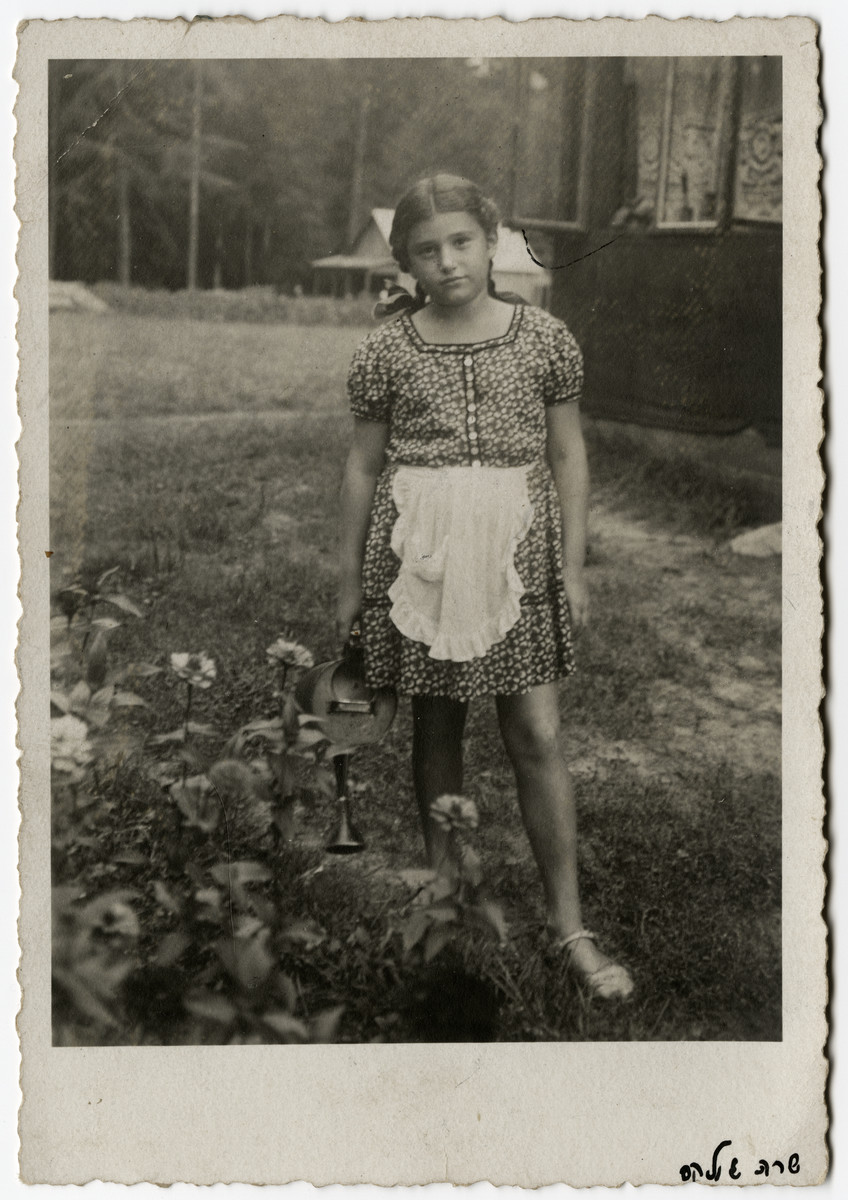 Portrait of Sarah Elkes standing in a garden.