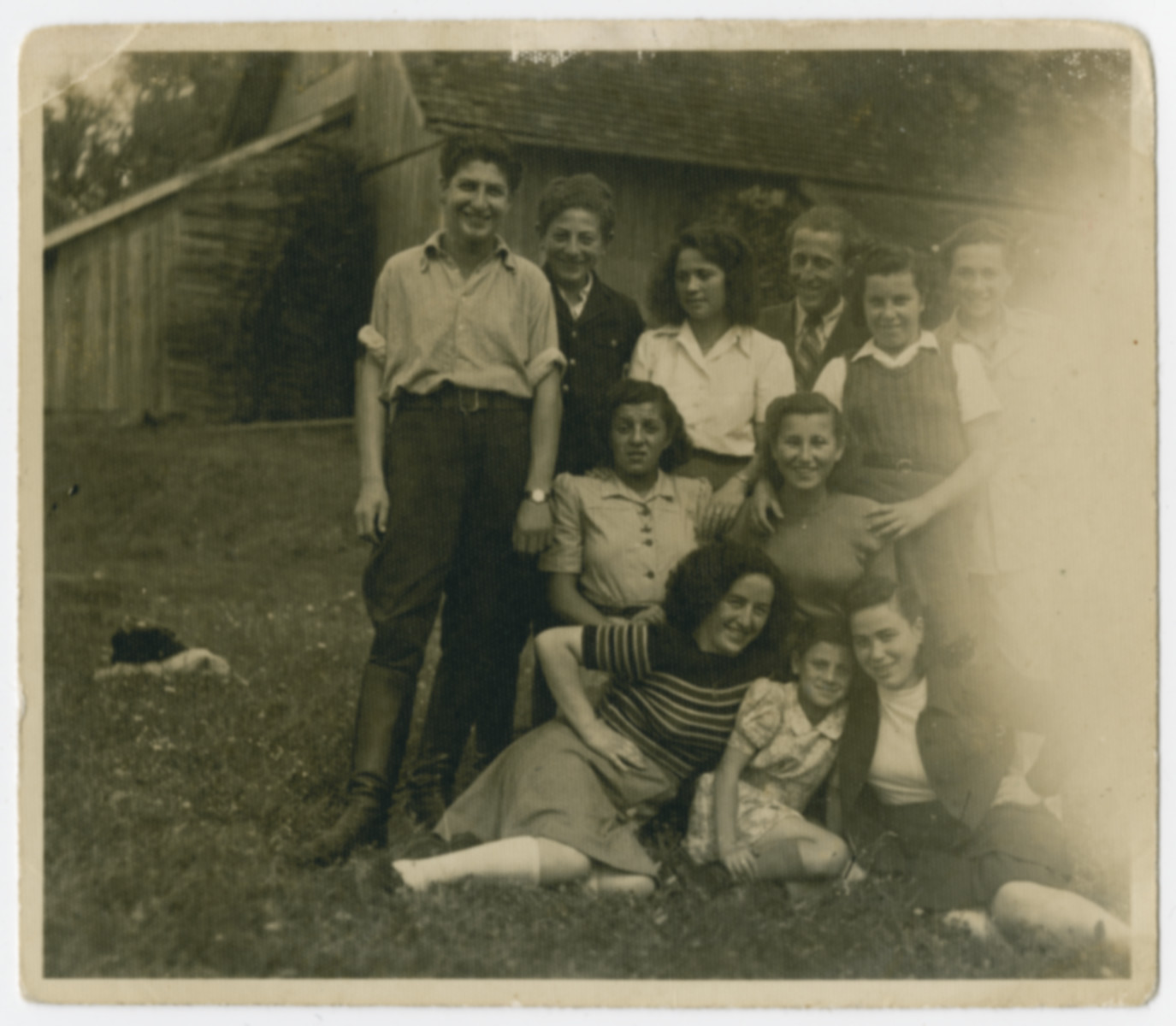 Group portrait of young people in the Holzhausen kibbutz hachshara.

Rifka Weiss is pictured seated in the front right.  Rochel is seated on the front left.