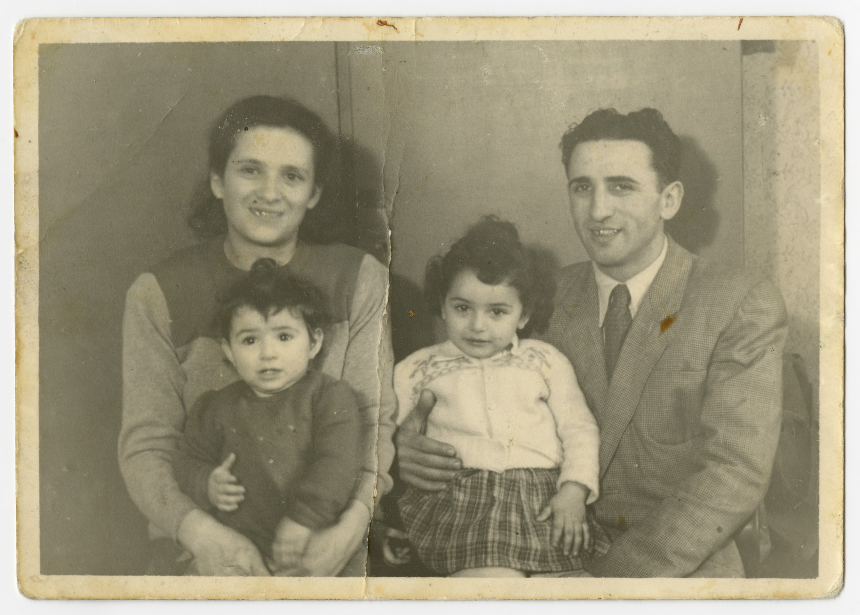 Portrait of the Zinger family in the Bergen-Belsen displaced persons camp.

Pictured are Malka holding Rosa, Ellen and Abram (b. Daum) Zinger.