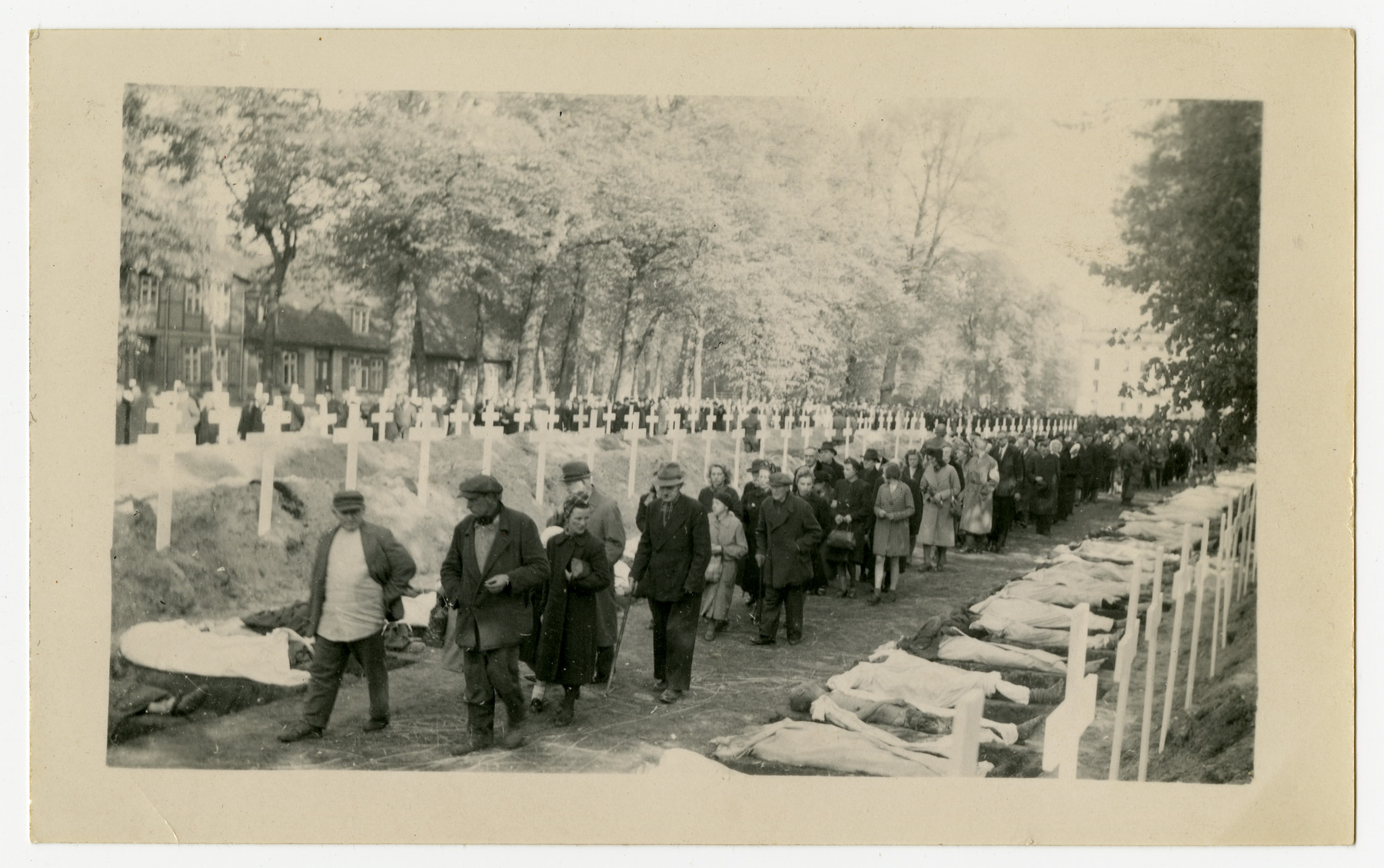 The population of Ludwigslust is forced to walk past the bodies of concentration camp victims prior to their reburial on the palace grounds of the Archduke of Mecklenburg.