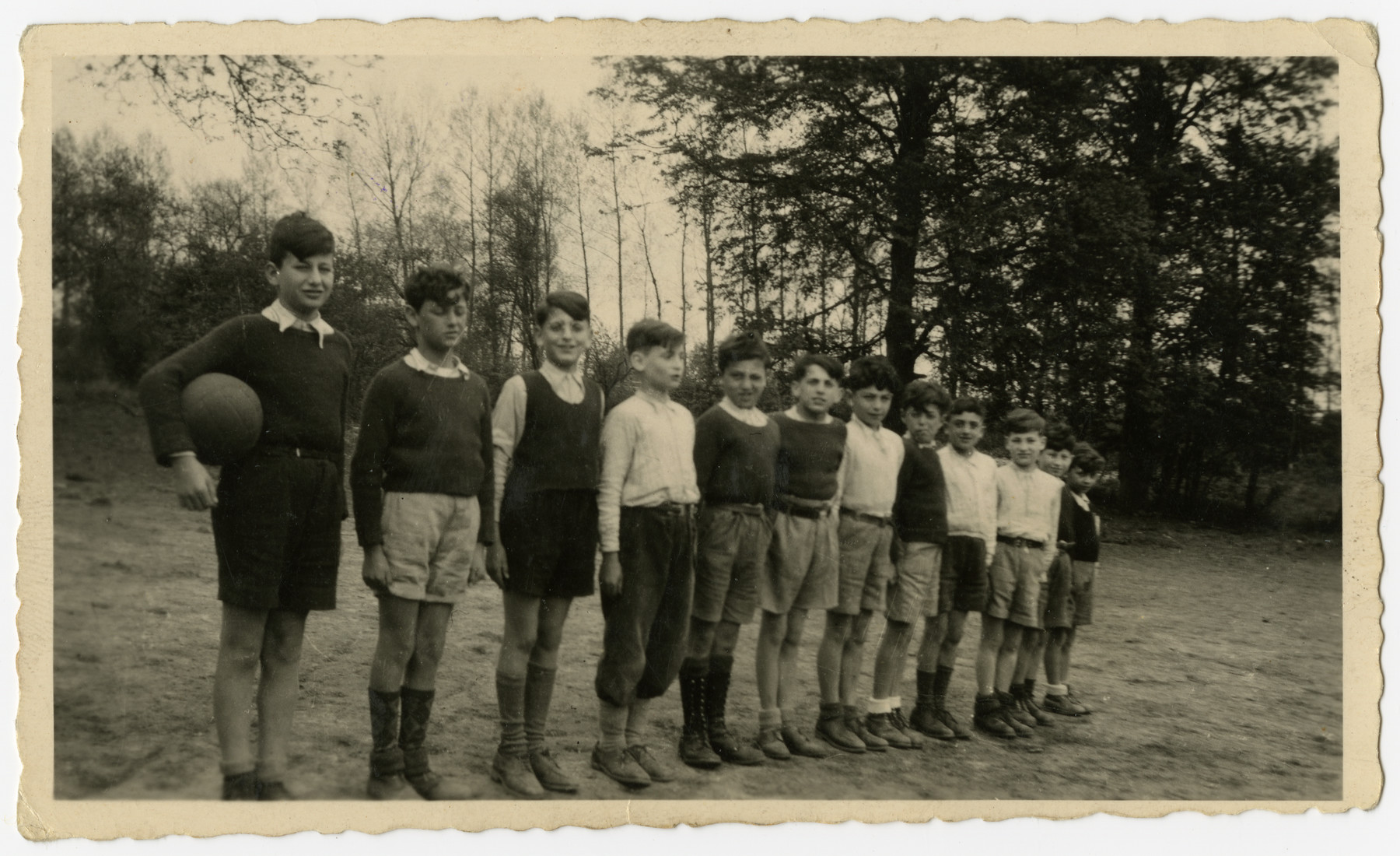 Jewish orphans in Home de la-Bas in Aische-en-Refail line up with a soccer ball.

Among those pictured are from left to right: Hans (last name ?), Leon Pec, Maurice Sorgenstein, Henri Beigel and Charles Rojer.  The others are unidentified.