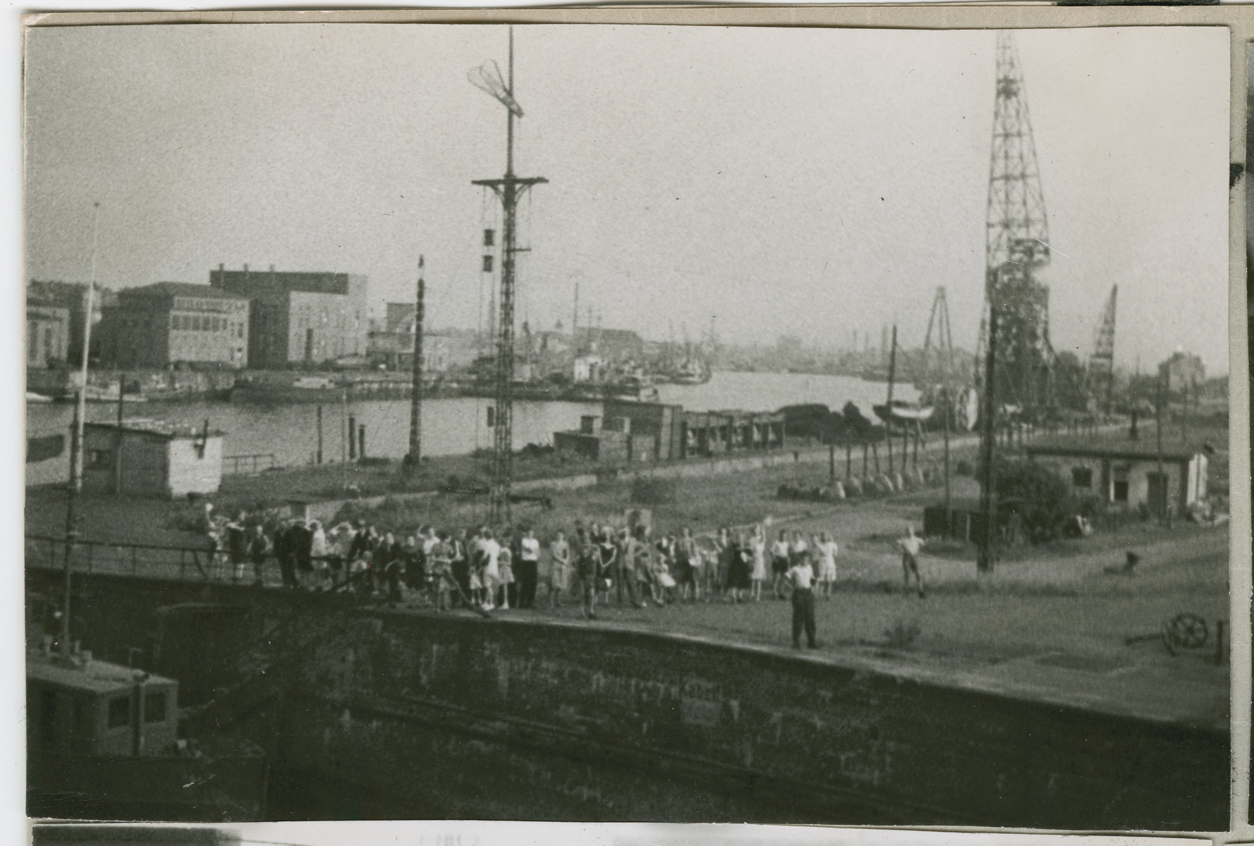 Men and women gather by the pier in Bremen to say good bye to the Marine Flasher.