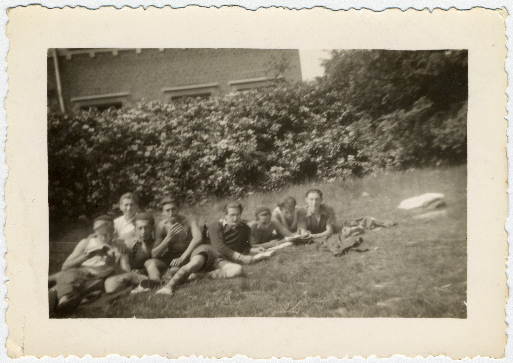 Belgian Jewish youth relax on the grounds of La Ramee, an agricultural training school.

The school was established after Jewish students were expelled from general schools  and directed by Haroun Tazieff.