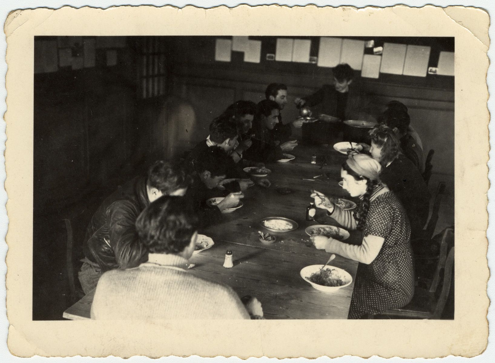 Jewish youth eat in the dining room of the La Ramee agricultural school in Belgium.

The school was established after Jewish students were expelled from general schools  and directed by Haroun Tazieff.
