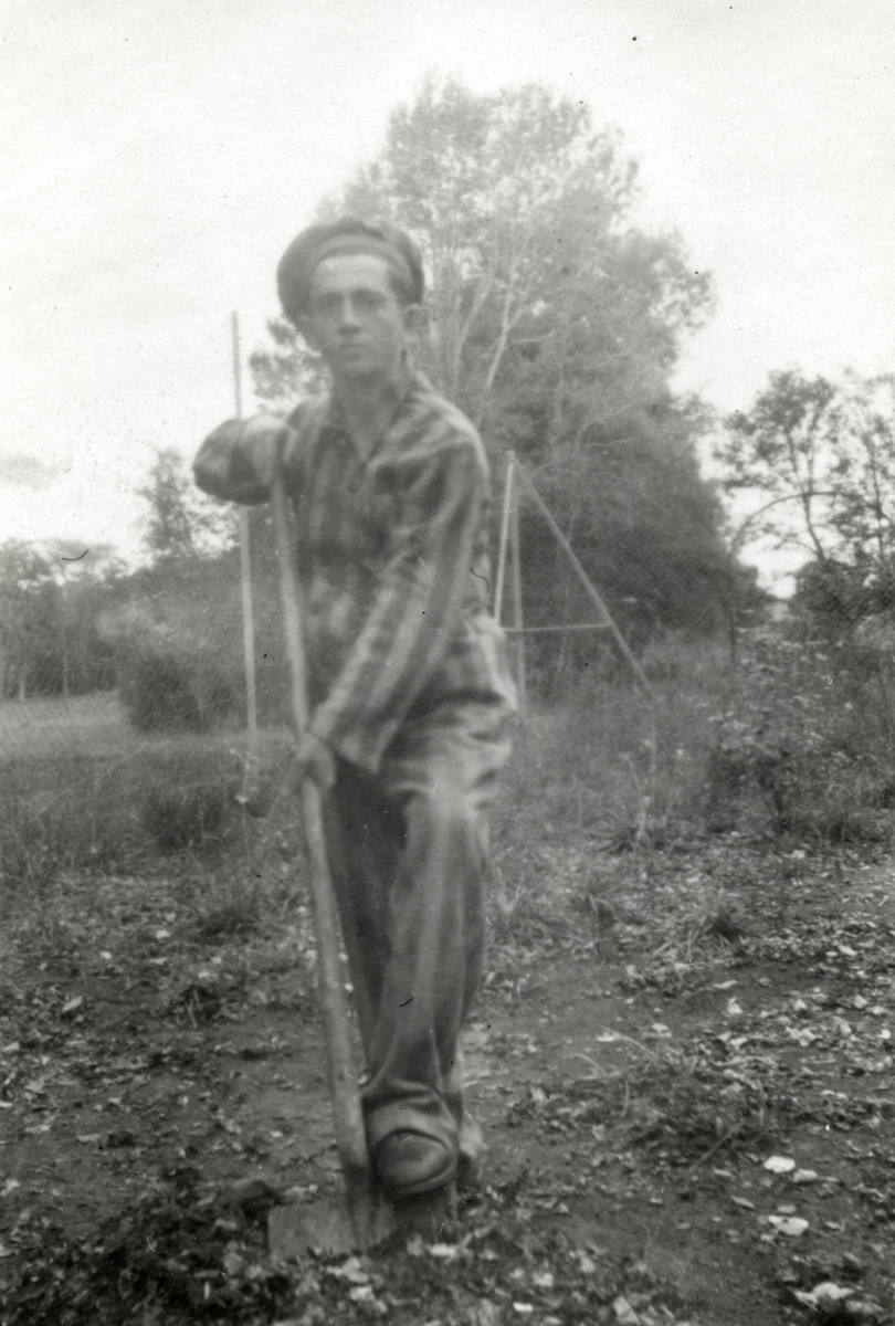 Binem Wrzonski digs in the garden of the Ambloy children's home while wearing an old concentration camp uniform.