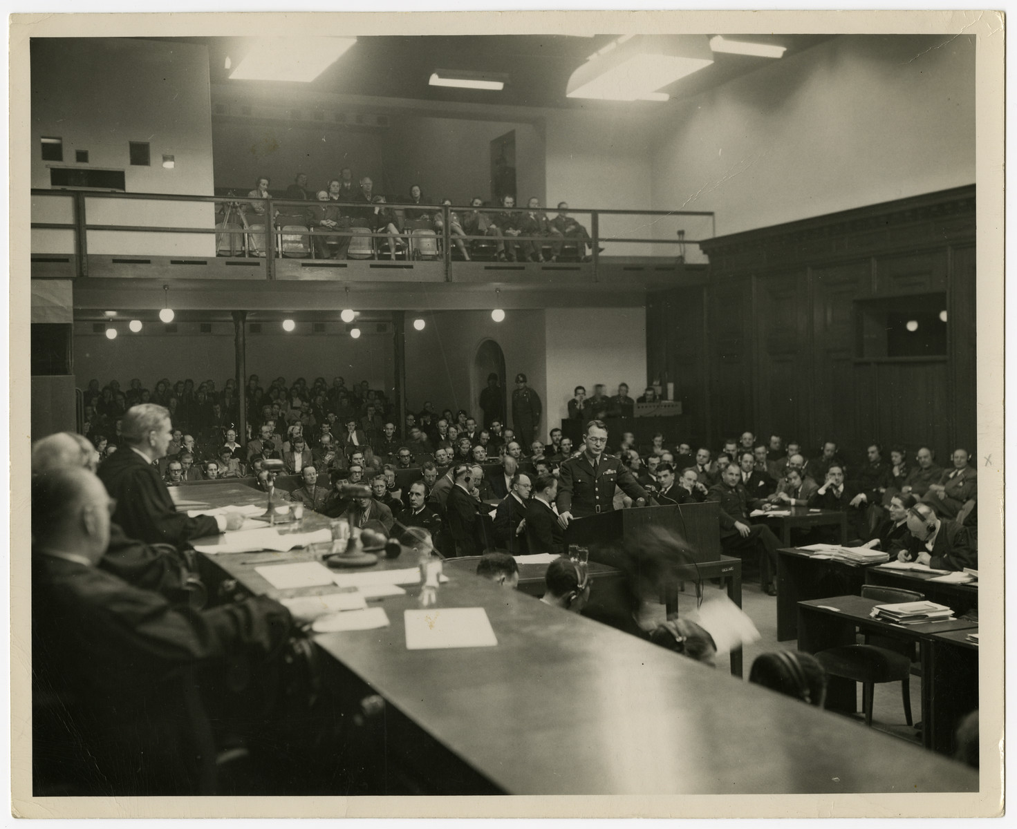 Telford Taylor, chief prosecutor of the Krupp Trial, testifies.

Seated to the right are the justices.