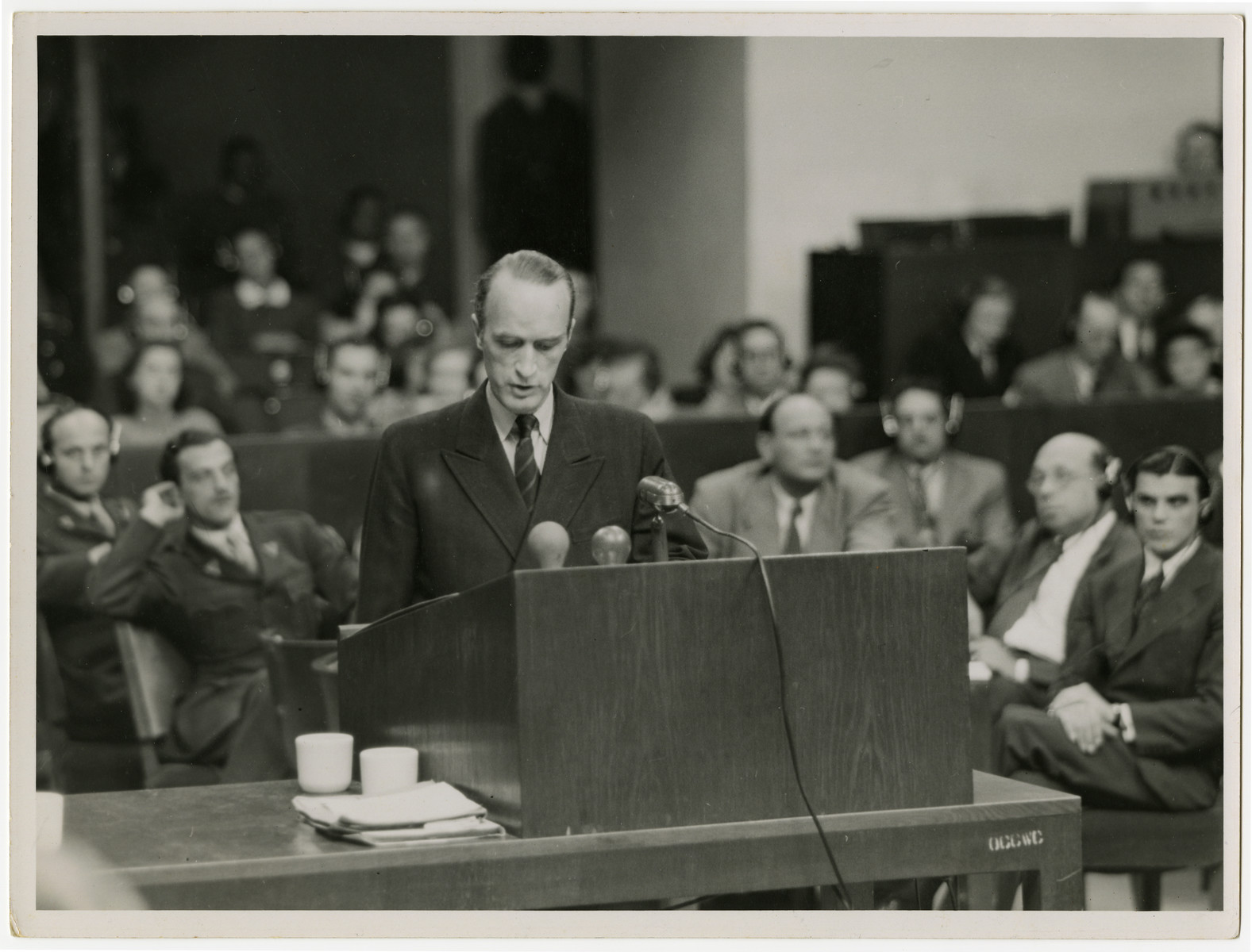 Defendant Alfred Krupp von Bohlen testifies at the Krupp Case war crimes trial.

Seated behind him to his right is Max Austein.