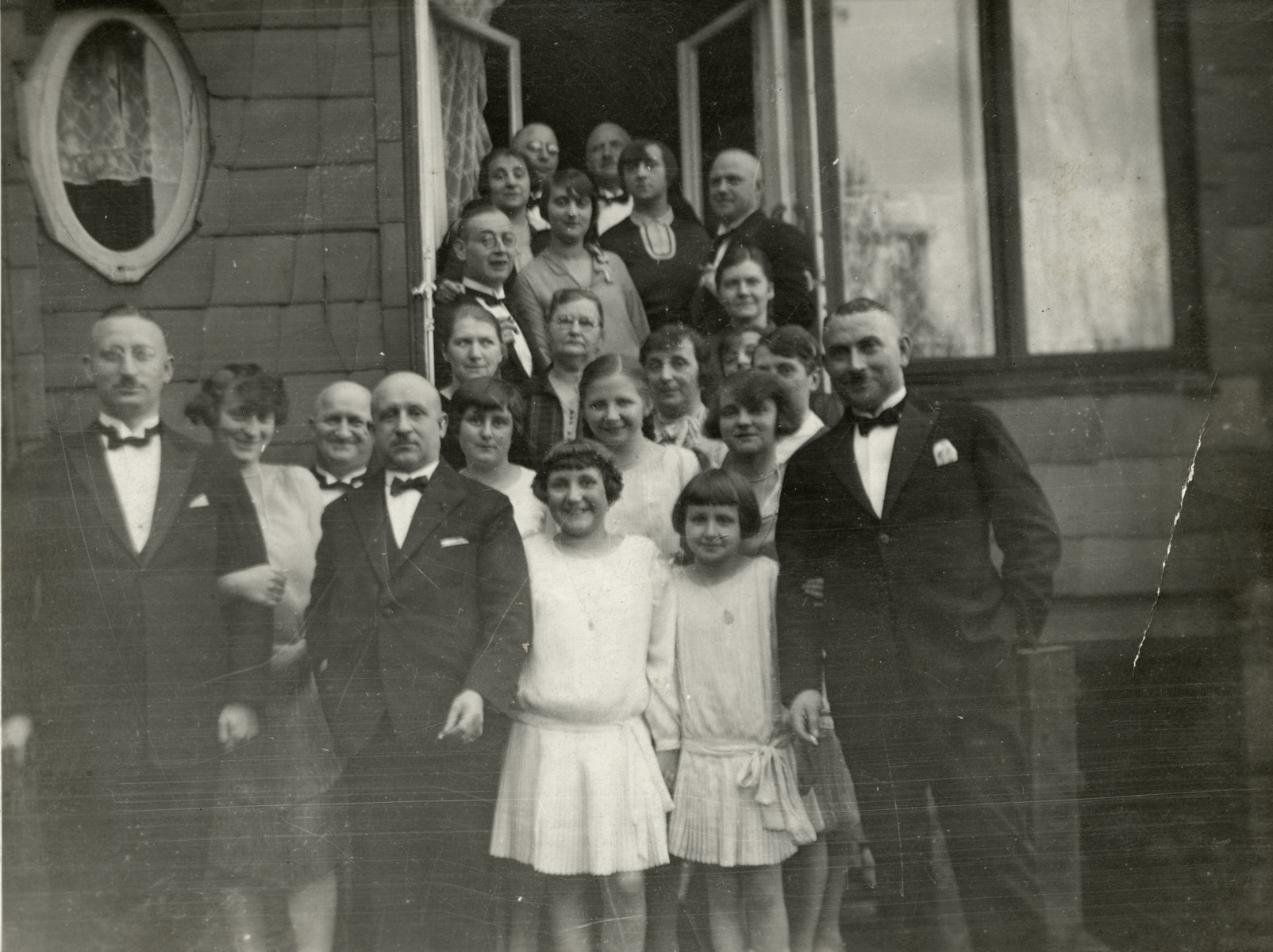 An extended family poses on the occasion of a first communion.