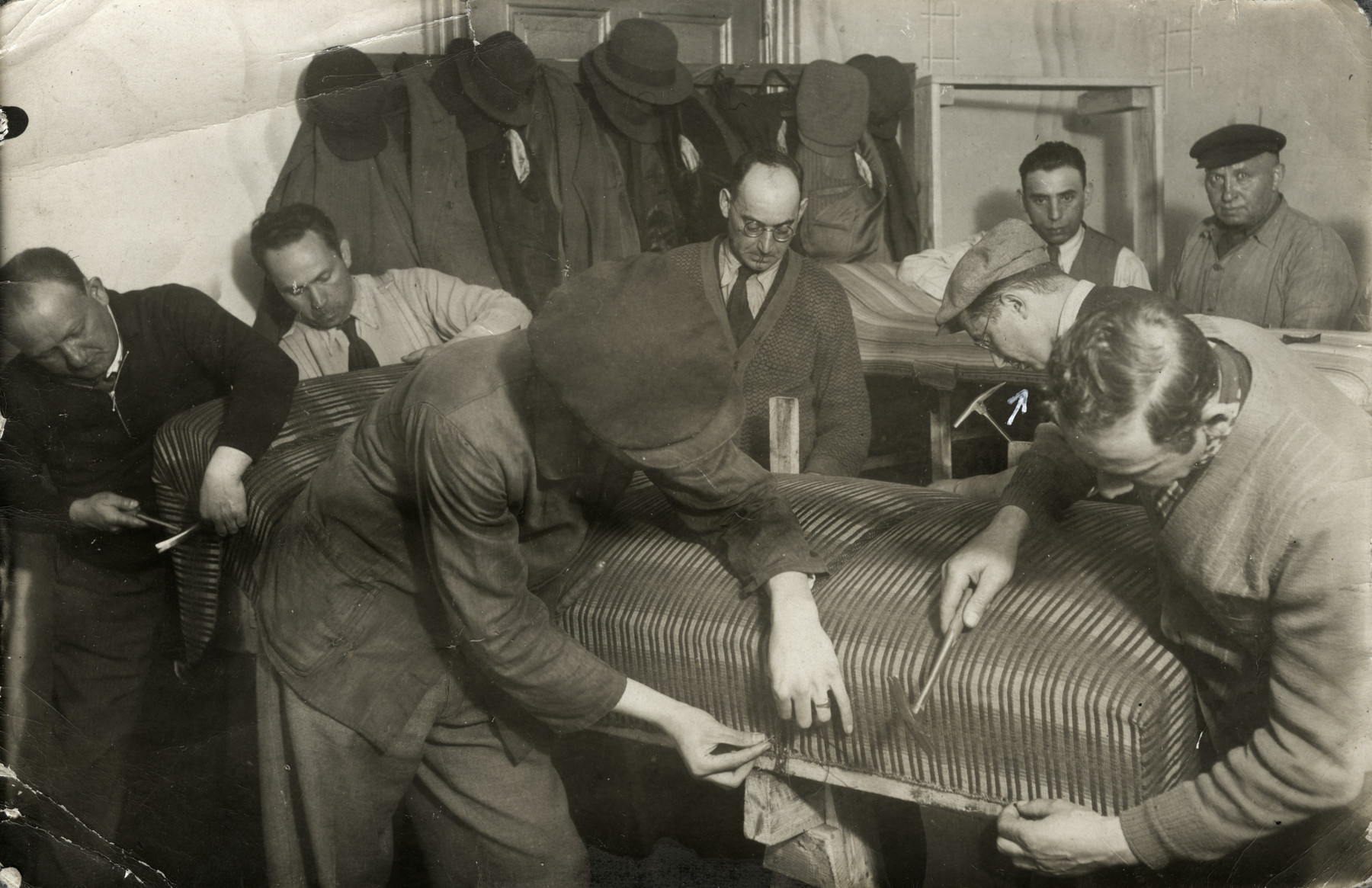 German Jews exiled to Zbaszyn reupholster furniture in a workshop.

Yehoshua Birnbaum is on the middle left with a cap and glasses.