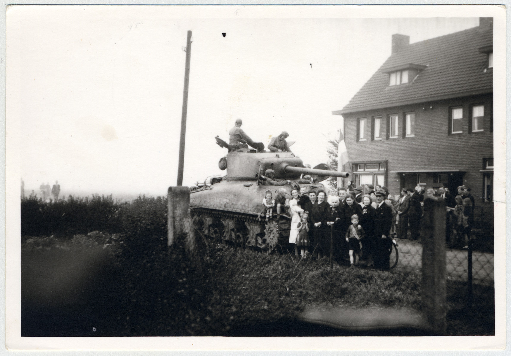 Residents of Treebeek welcome a Canadian tank who is liberating the village.