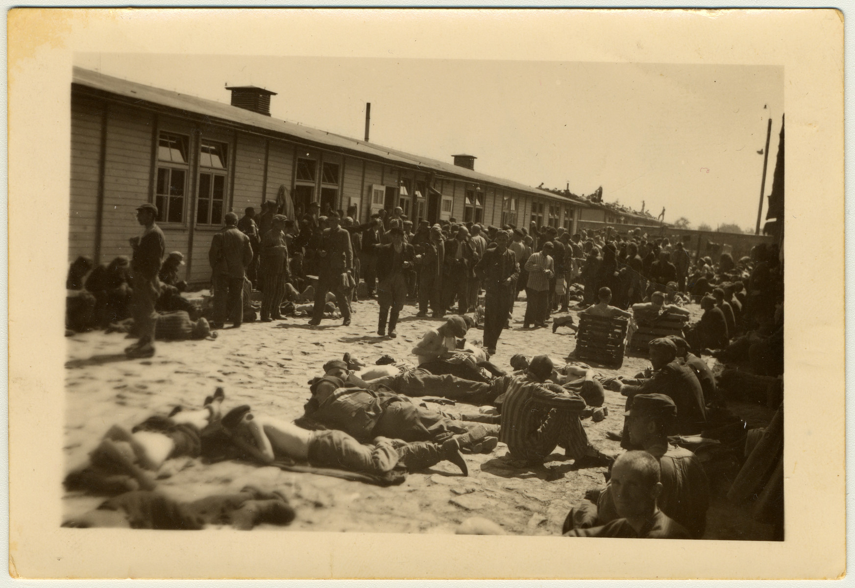 Survivors gather outside a barrack of the Mauthausen concentration camp after liberation.