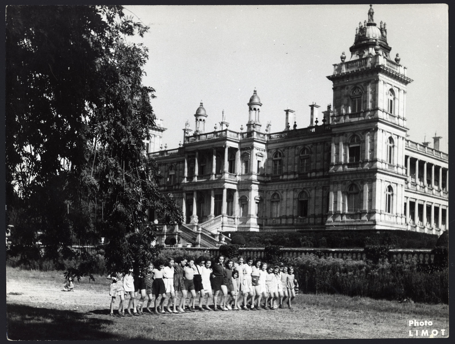 Girls walk in a row on the grounds of the Rothschild castle.

The original caption reads "Vacation at the Rothschild castle."