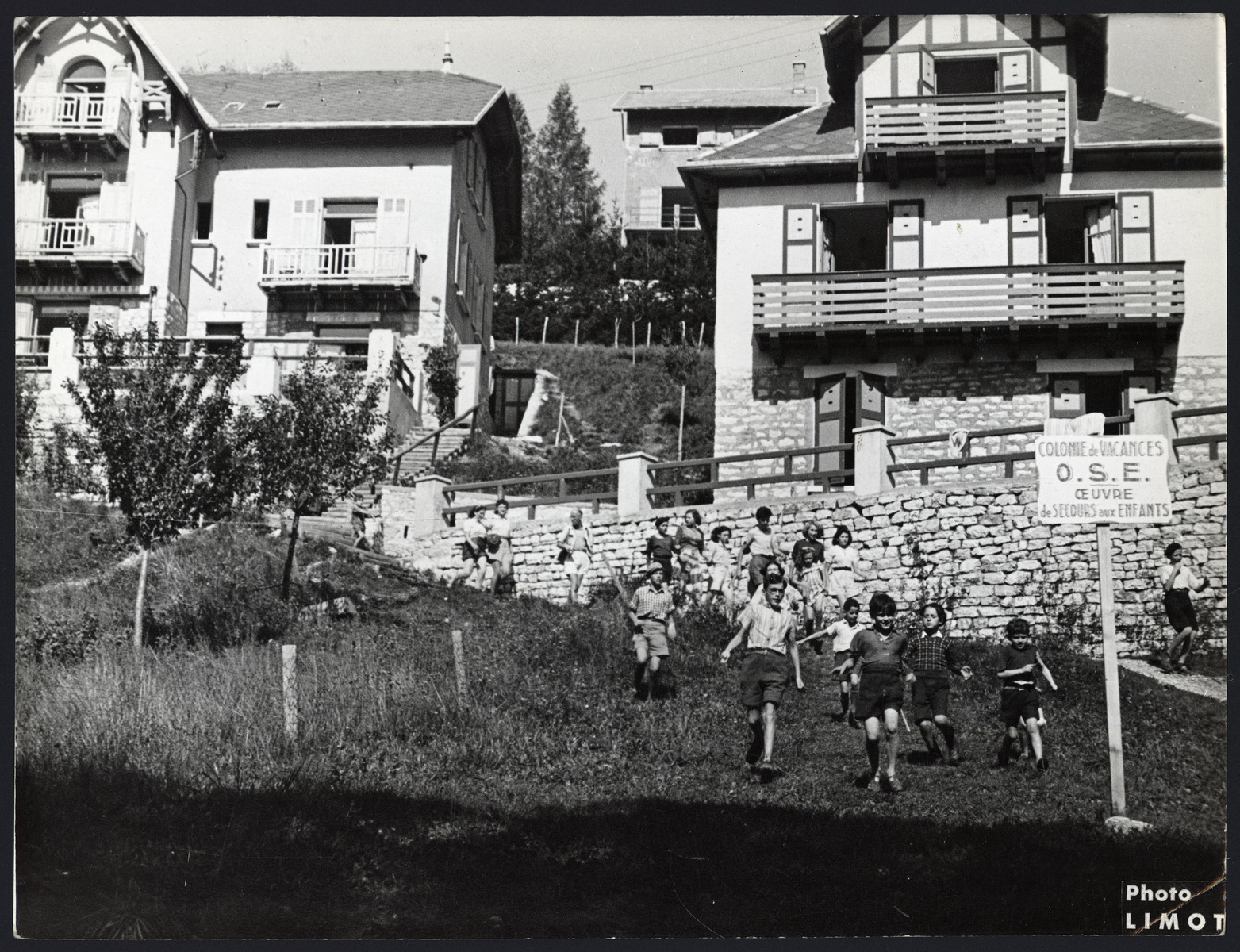 Children play outside in an OSE vacation home in Grenoble.

The original caption reads "July at the Colony in Grenoble."