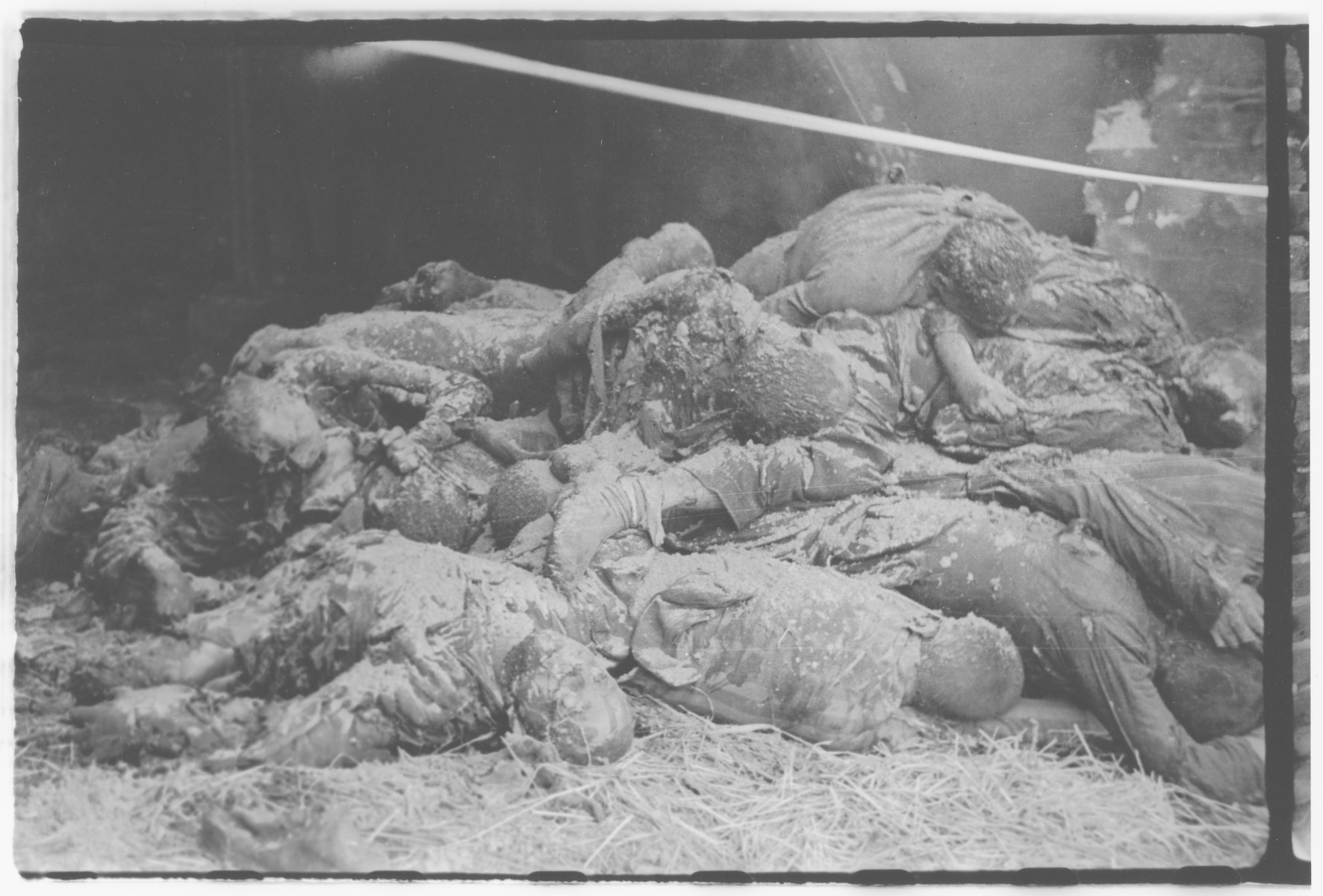 A pile of burned corpses, victims of the Gardelegen Atrocity, lie piled in a barn.