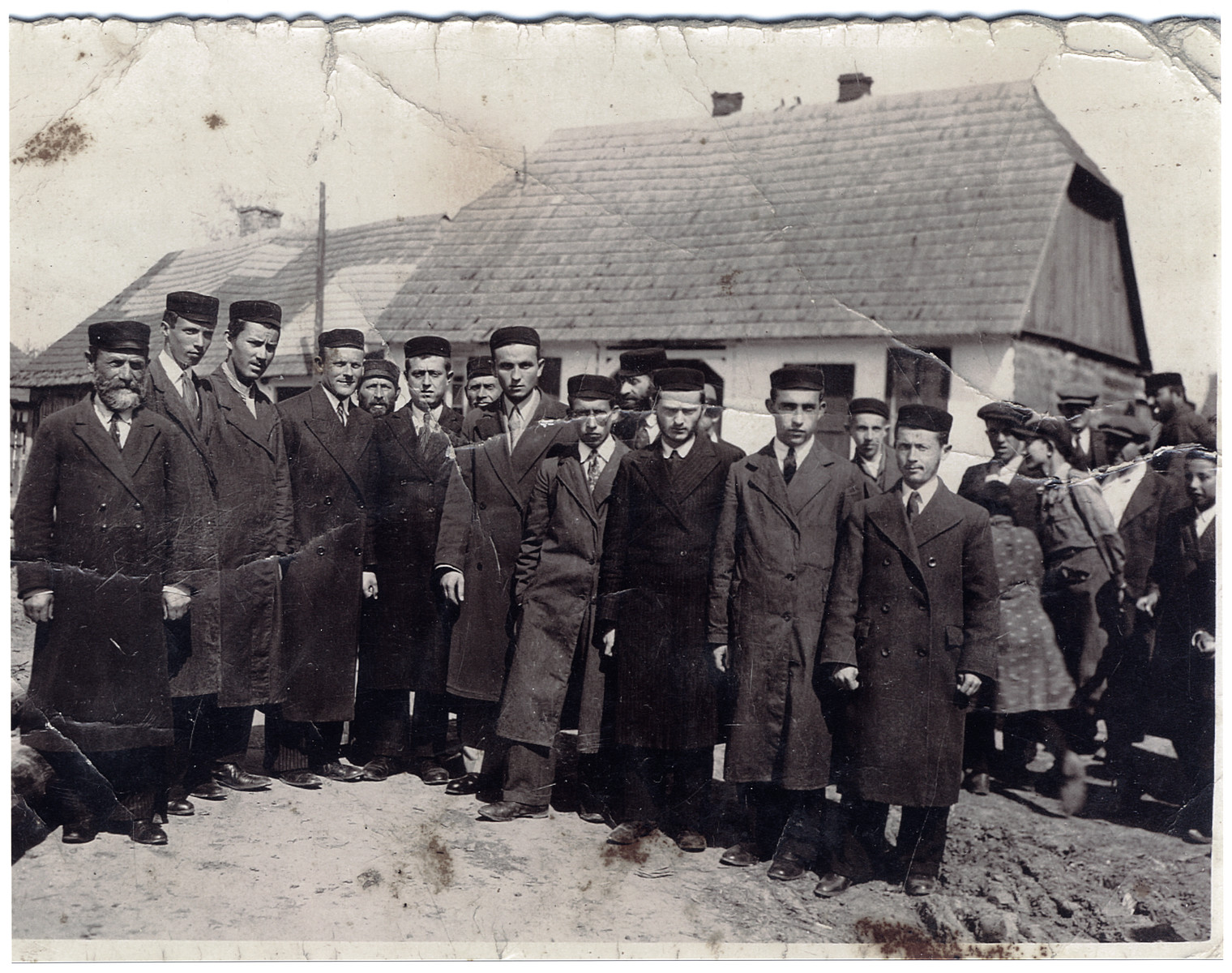 Group photograph of Chassidic Jews in the town of Wachok, Poland.  

Among those pictured are Mendel Lustman (far right) and his brother Pinchas Lustman (fourth from the right).  On the far left is Chaim Binstok.