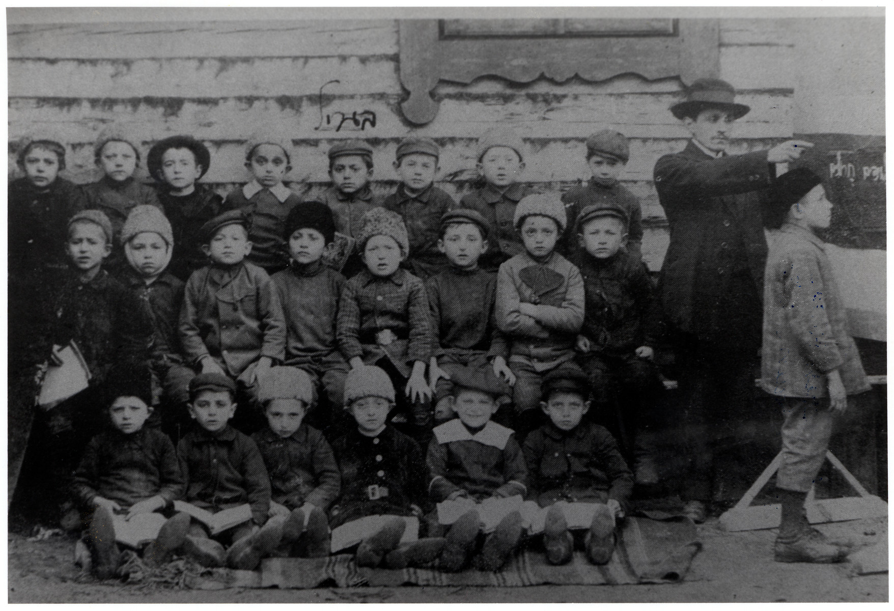 Group portrait of young boys in a cheder, Chevra Hebraisher, in Drohicyn.

Menachem Rosenbaum is frirst  on left,  The teacher is  Mr. Lehrer.