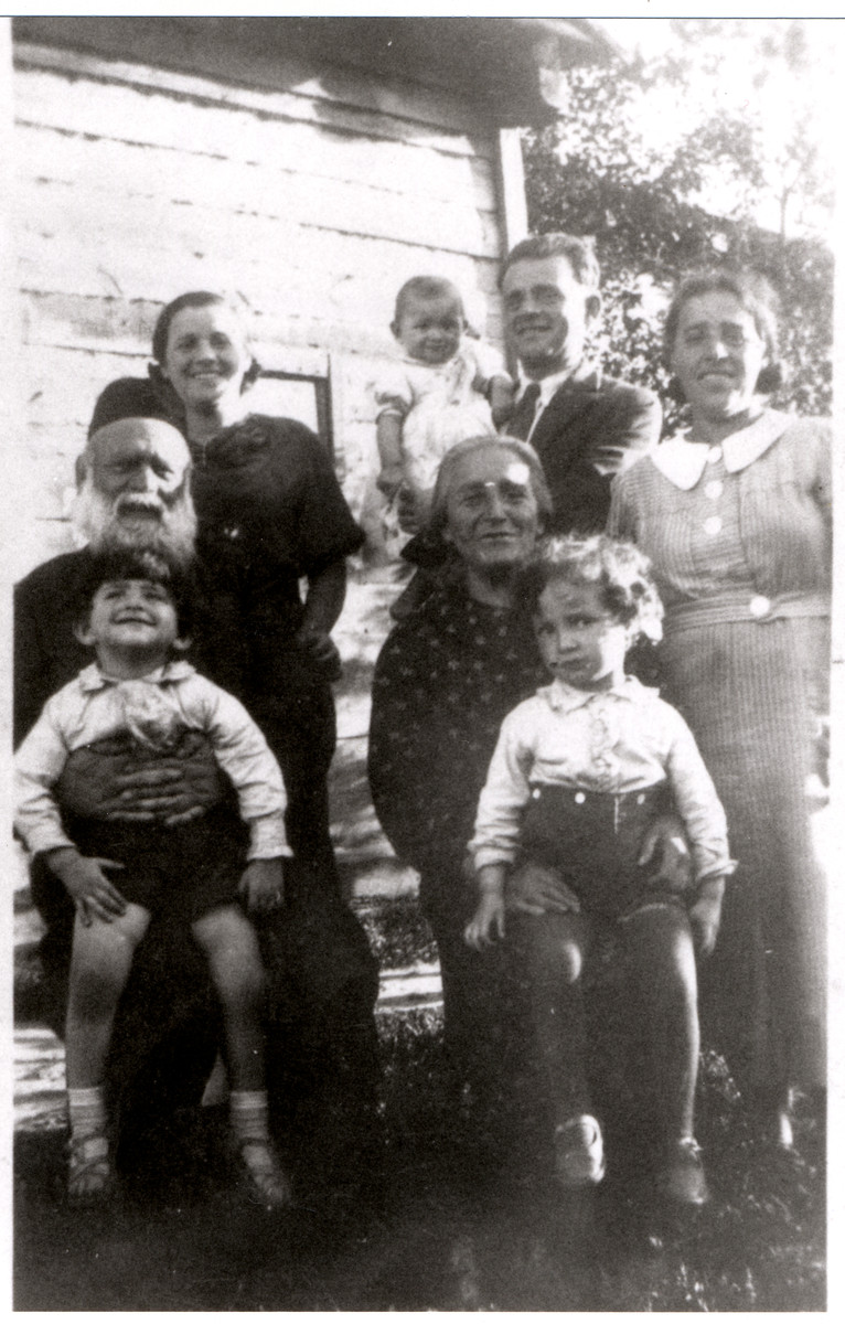 Group portrait of the Rosenbaum family in prewar Drohiczyn.

Standing left to right are Zlata Riva Rosenbaum (Grynblatt), Menachem Rosenbaum holding baby Henye and Chaieh Gutah Leah Rosenbaum Taumtschen.  Seated left to right are Aron Rosenbaum holding Menachem's Yosef and Chana Malka P. Rosenbaum holding Guta Leah's Yakov Leib.