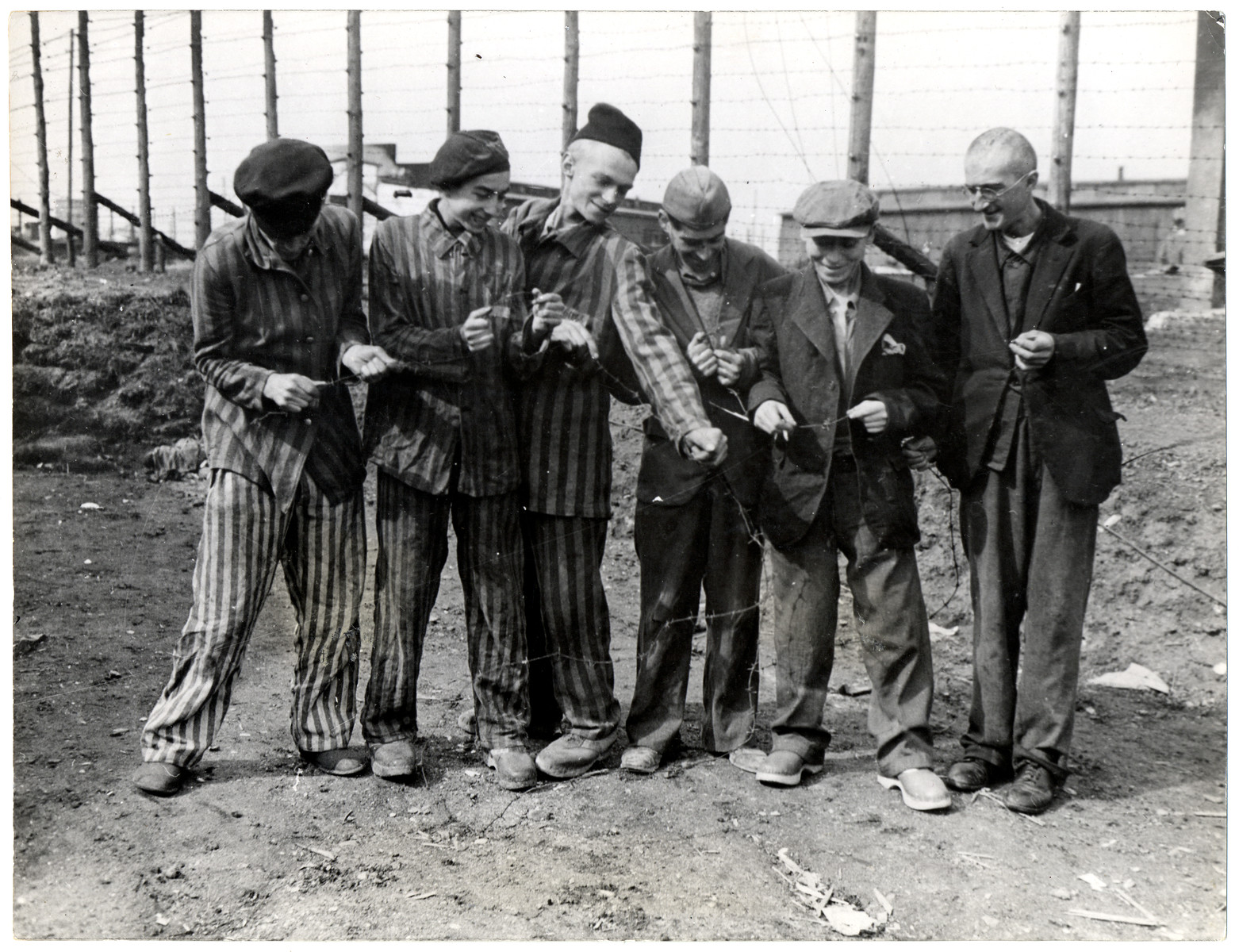 Survivors of the Hanover concentration camp destroy the barbed wire that had held them captive.

Original caption reads; "Former Jewish and Polish prisoners of the Nazis laugh at the barbed wire which for years held them captive at the Nazi Hanover-Harlen concentration camp near Hanover, Germany, captured by troops of the Ninth U.S. Army April 10, 1945. Hanover is 155 miles from Berlin."