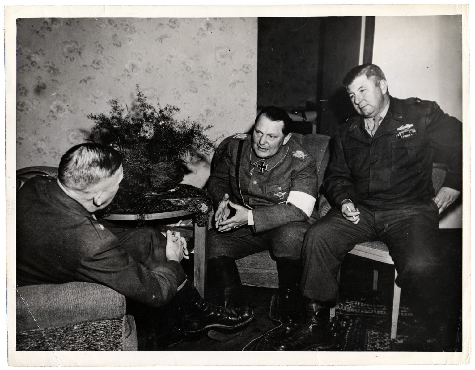 Hermann Goering (center) talks with Brigadier General Robert J. Stack, Assistant Commander of the 36th Infantry Division (right) and Major General John Dahlquist, Commander of the 36th Division after his arrest in the Grand Hotel at Kitzbuehl.

Original Caption: "Herman Goering, second to Adolf Hitler in the Nazi Party hierarchy, was captured by troops of the 36th Division, Seventh U.S. Army, at Kitzbuehl, Austria, it was announced May 9, 1945, by Supreme Headquarters Allied Expeditionary Force. He surrendered to Brigadier Gerneral Robert J Stack, Assistant Commander of the 36th Divion. Goering said that the last time he spoke to Hitler was April 24, 1945, when he said he telephoned the Fuhrer and suggested that he assume command as Germany was being cut in two. Goering claimed that Hitler had become outraged, accused him of losing faith and said that the death sentence would be passed."
