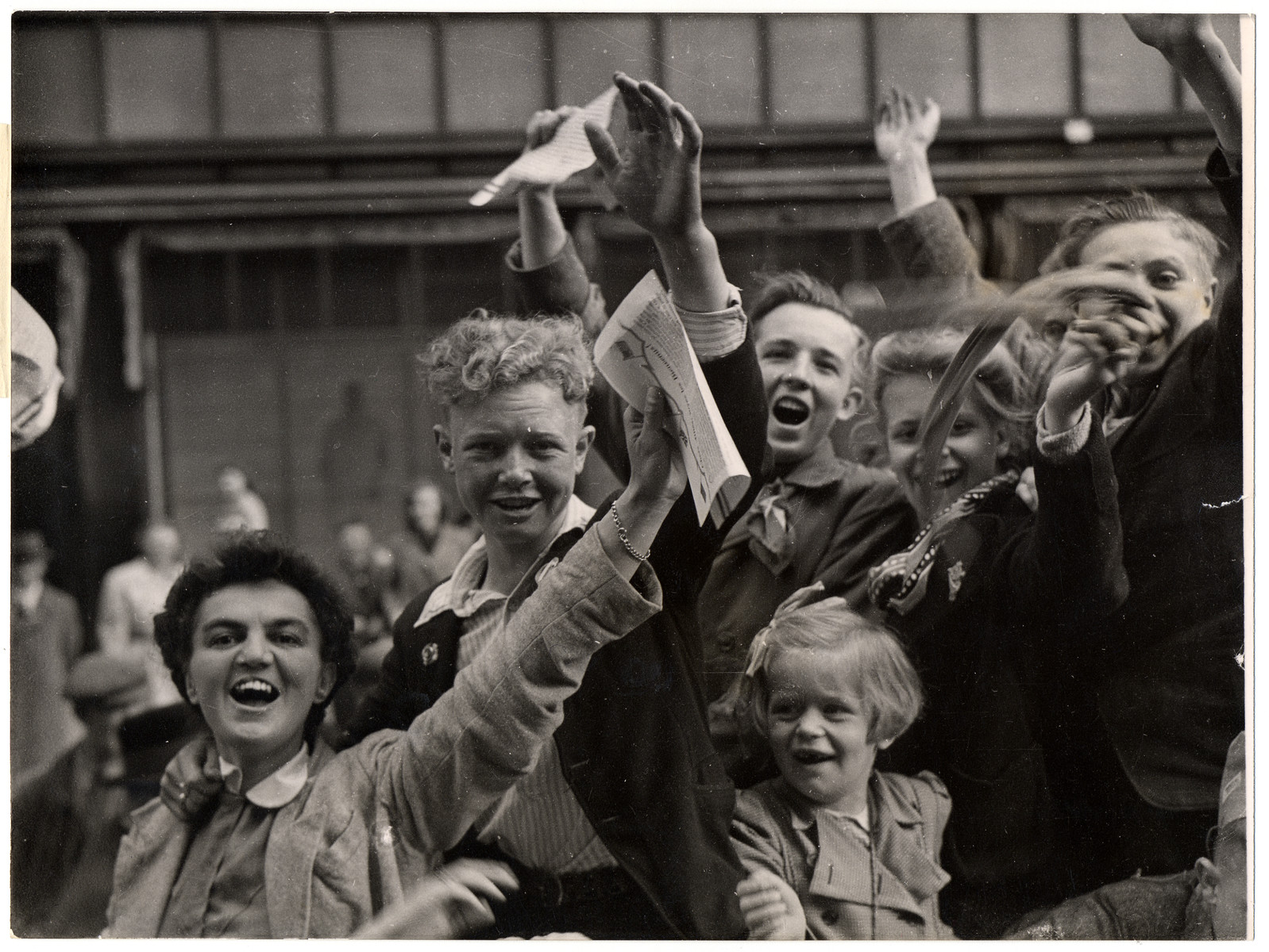 Dutch civilians celebrate their liberation by Allied troops.

Original Caption: "Victory crowds celebrating in the streets of Utrecht, Holland, were fired on by Nazi fanatics hiding in a building overlooking the parade. After a sharp skirmish, the Germans were captured by Dutch patriots and the celebration was resumed. Here, the cheering Dutch continue their celebrations of the Allied victory in Europe and their own liberation after five years under German occupation"