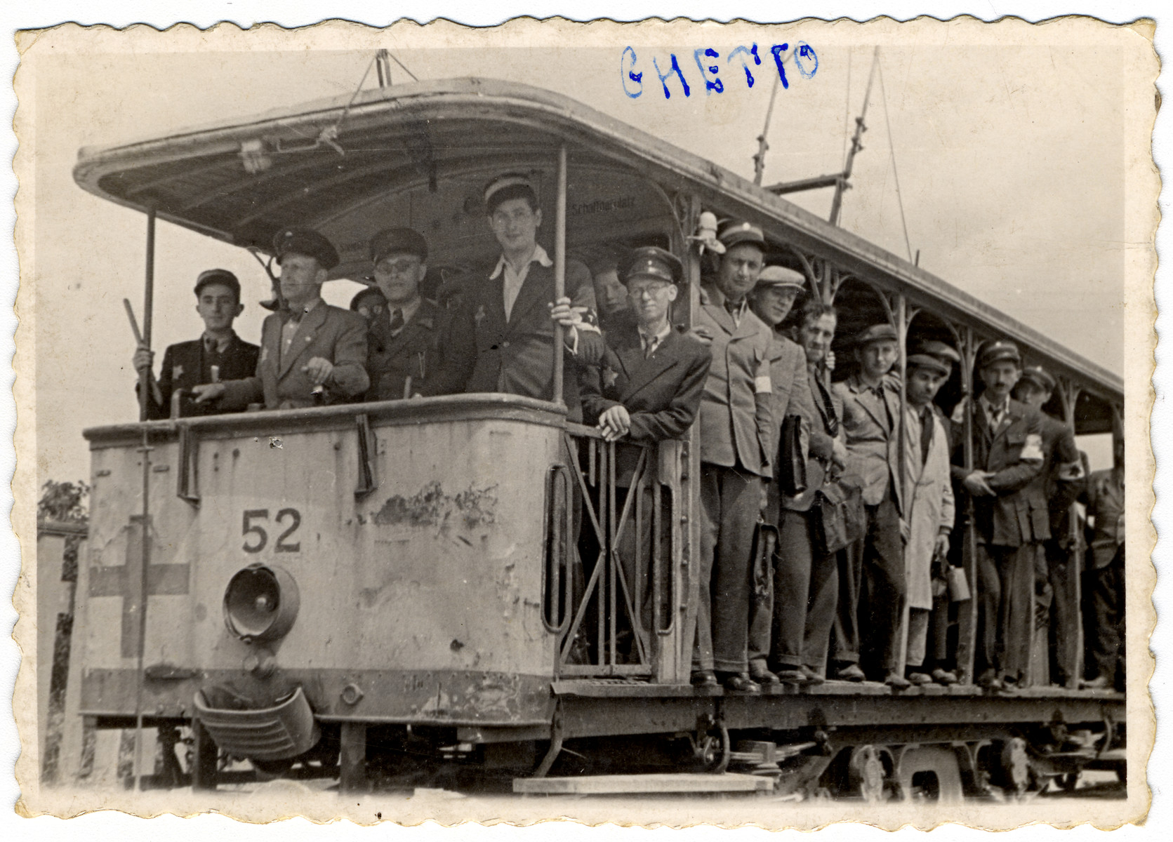 Group portrait of Jewish policemen posing on a streetcar of the Lodz ghetto.  The driver of the streetcar is Rozenbaum.